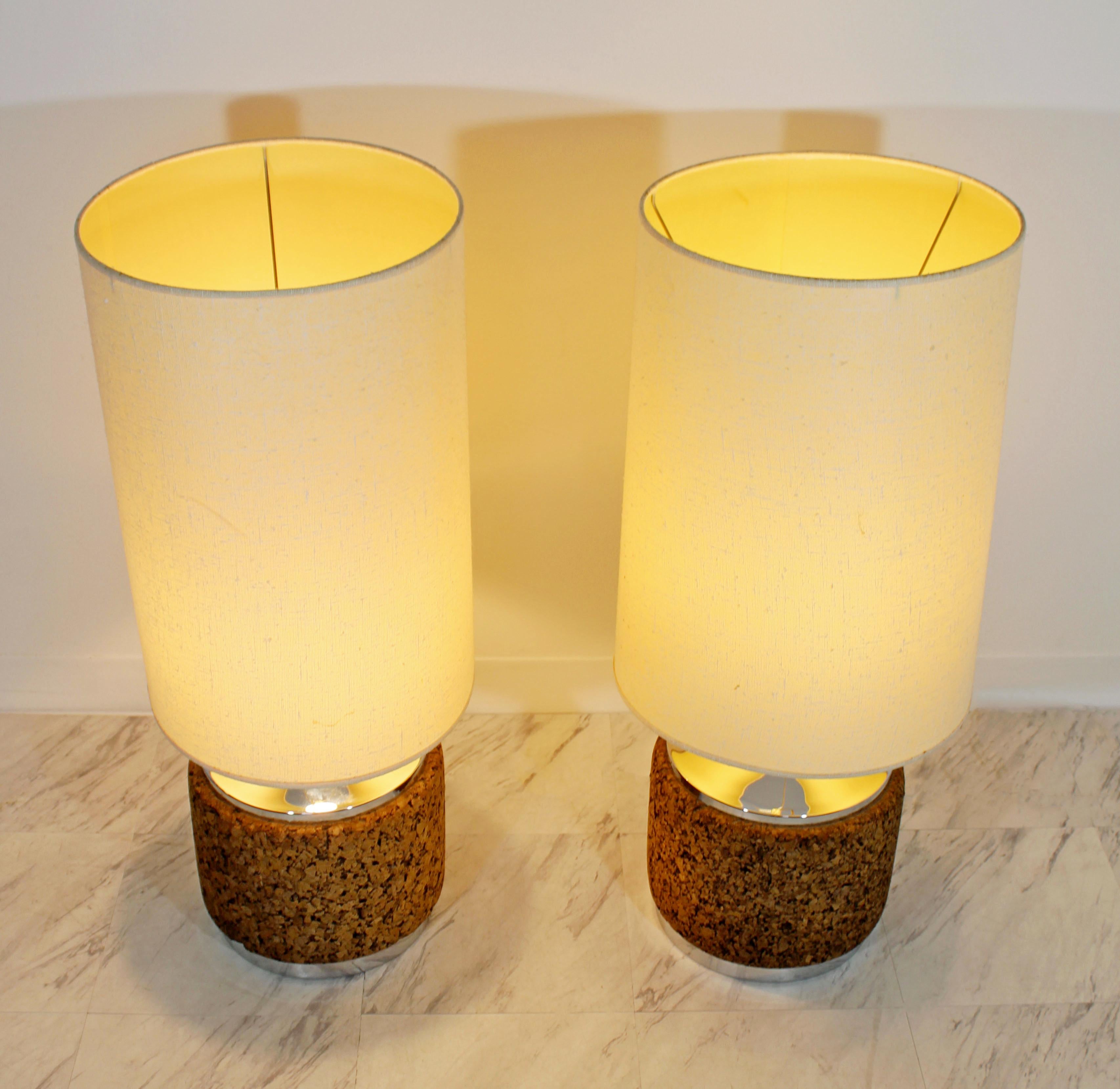 For your consideration is a unique pair of cork drum table lamps, with chrome bases and tops and original brass finials, circa the 1970s. In excellent condition. The dimensions of the lamps are 11