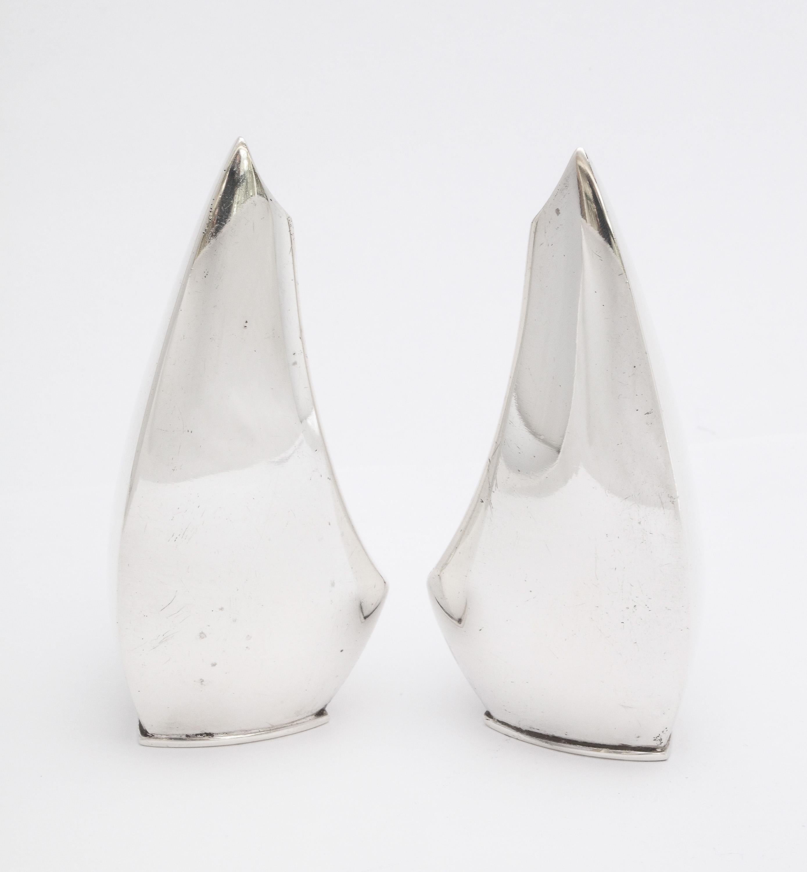 Mid-Century Modern pair of sterling silver salt and pepper shakers, Denmark, circa 1950s, ABSA - maker. Each shaker is 3 inches high x 1 1/2 inches wide (at widest point) x 1 1/2 inches deep (at deepest point). Graceful design. Dark spots in photos