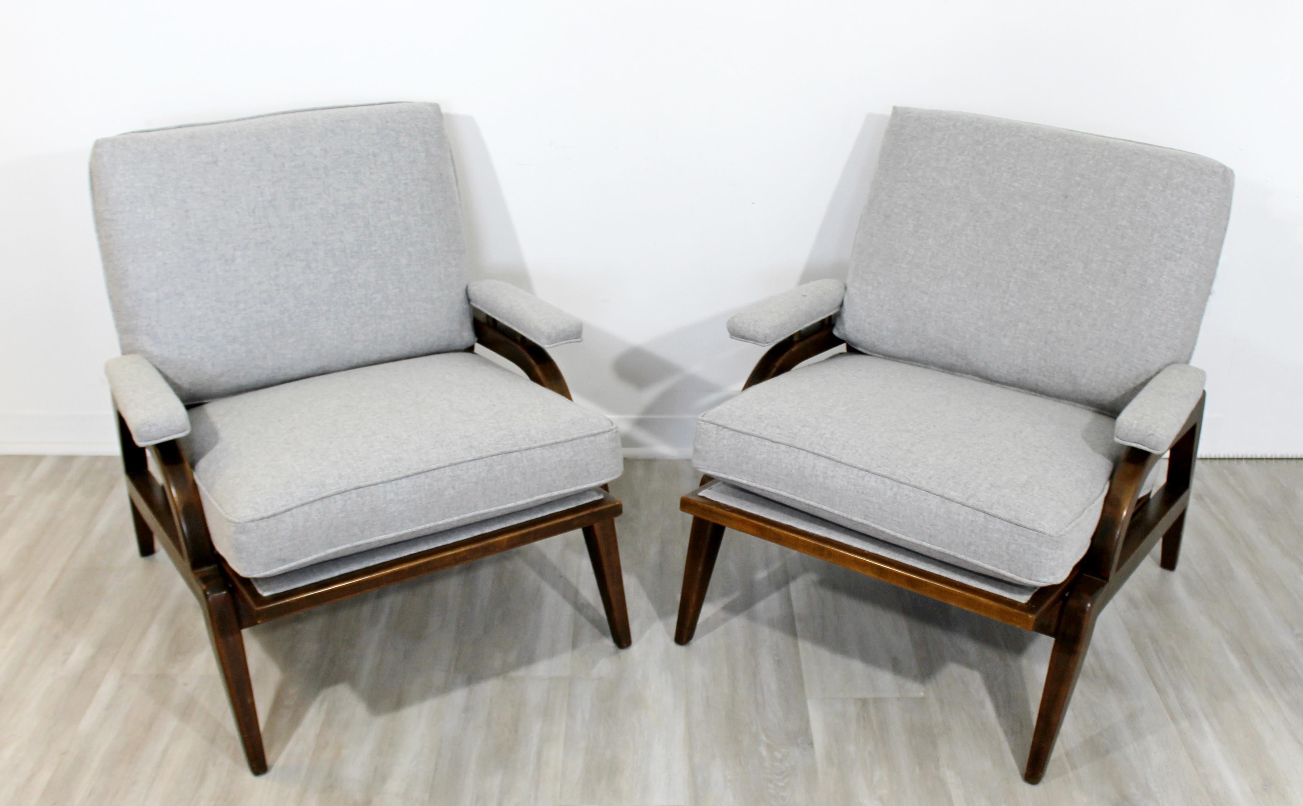 For your consideration is a phenomenal pair of wood armchairs, with delicately angled arms, in the style of Dunbar, circa 1960s. In excellent vintage condition. The dimensions are 29