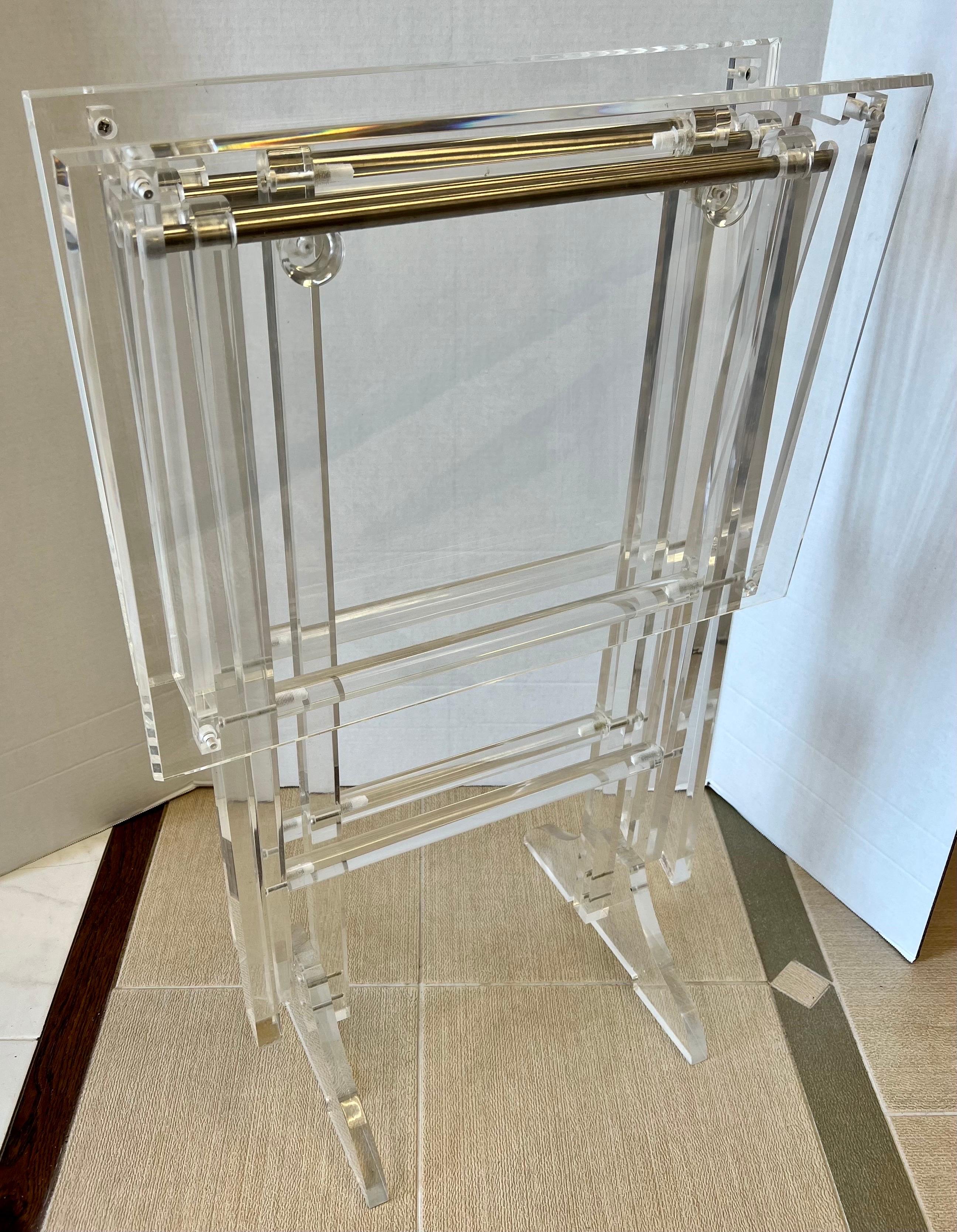 Sleek and sexy fold up TV trays? Yes! they are all lucite and sit on a secure lucite stand when they are not in use. Iconic mid century modern lines. Great scale.
Why not own the best?.