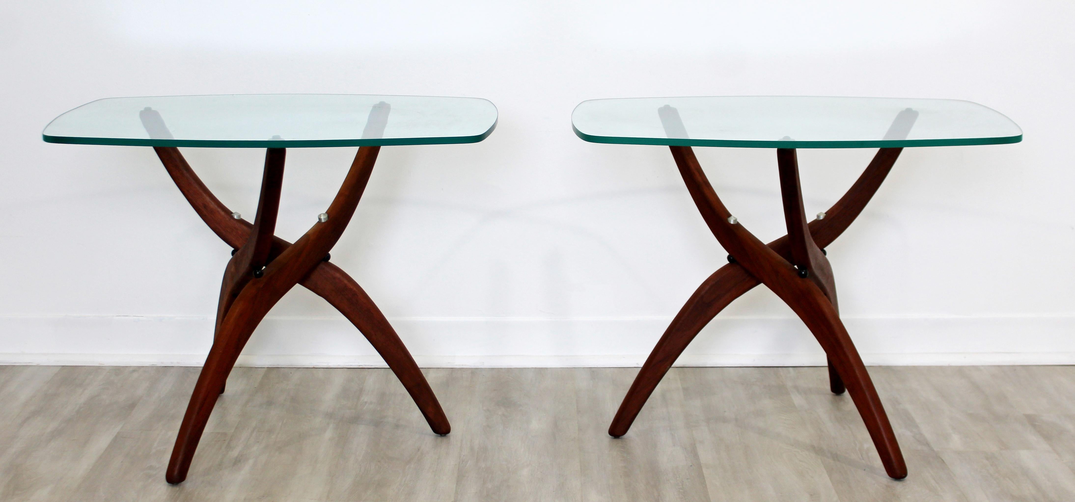 For your consideration is a marvelous pair of walnut and glass side or end tables, by Forest Wilson, circa 1960s. In excellent vintage condition, with a minor chip in one of the tops. The dimensions of each are 27