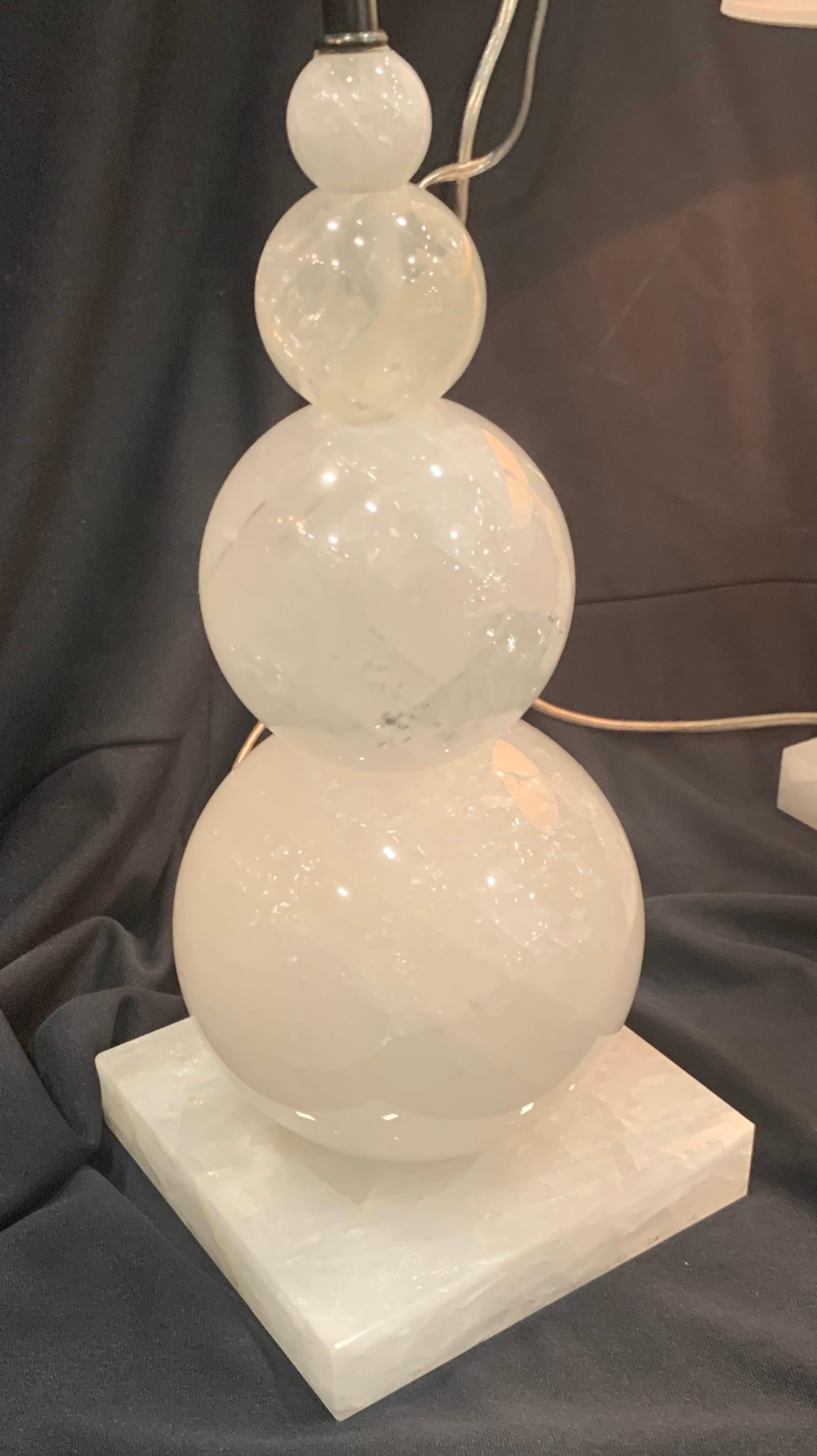 Wonderful Mid-Century Modern pair of graduating rock crystal round ball form lamps.
Measures: 25” height x 6 1/2” square at base.