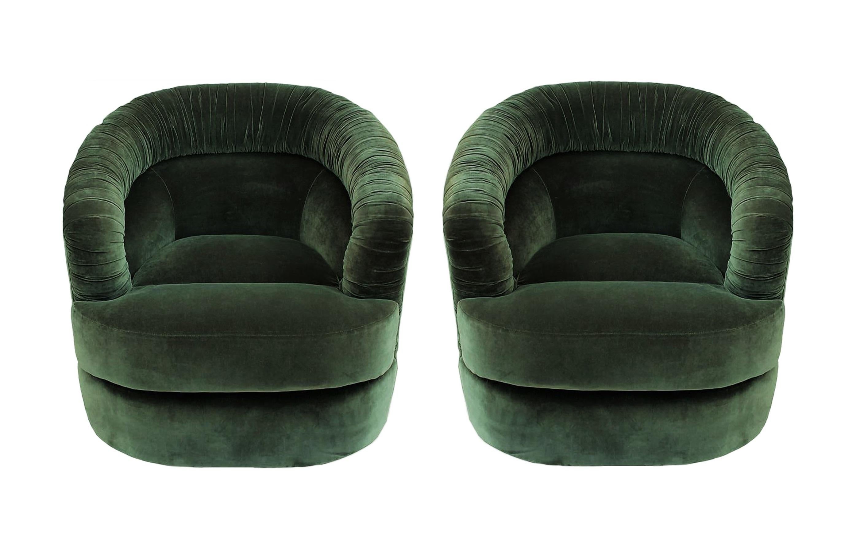 Mid-Century Modern pair of Milo Baughman style swivel club chairs. Each lounge chair features a unique tucked and ruched pleated barrel backs with the uppers raised on swiveling hidden base. Reupholstered in a subtle shade of green velvet fabric.