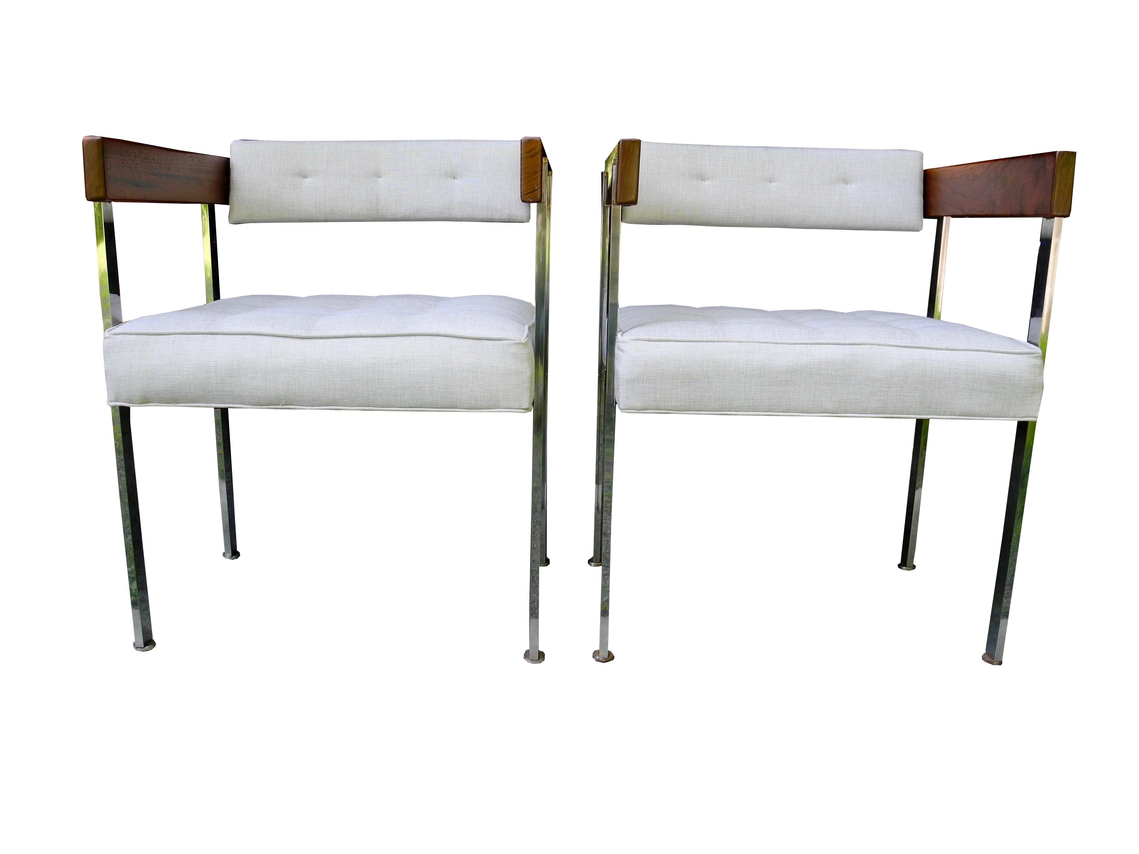 These upholstered pull-up chairs are designed by Harvey Probber for the living room or office. Upholstered in a linen blend neutral fabric with walnut arms and a solid polished stainless steel base. Sold as a set but two more are available.