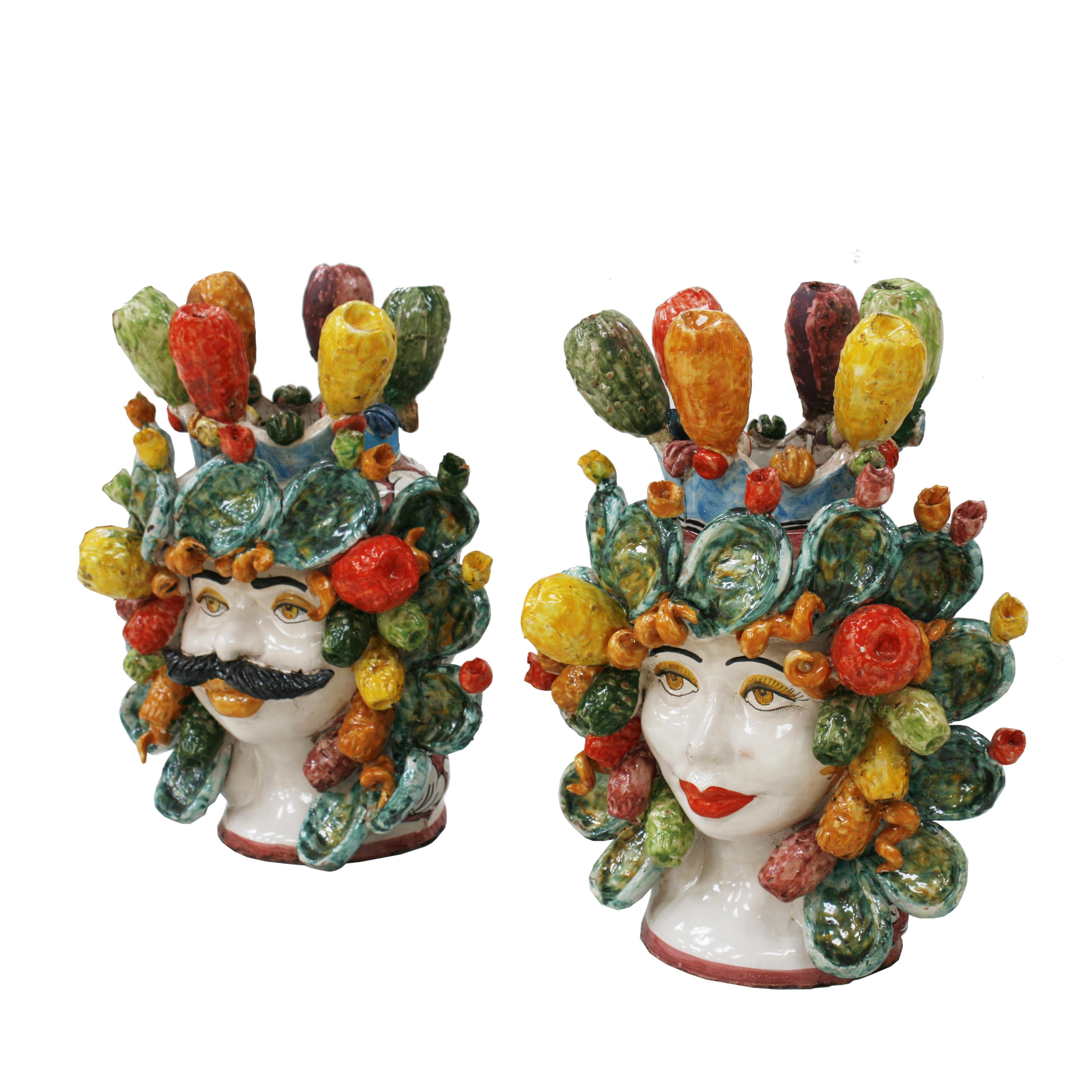 Pair of Sicilian vase with heads shape, hand painted made of colored terracotta ceramic, Italy. It is completely handmade following the ancient Italian and Sicilian tradition to turn and paint the ceramic by hand.

Sicily is famous for its ceramic