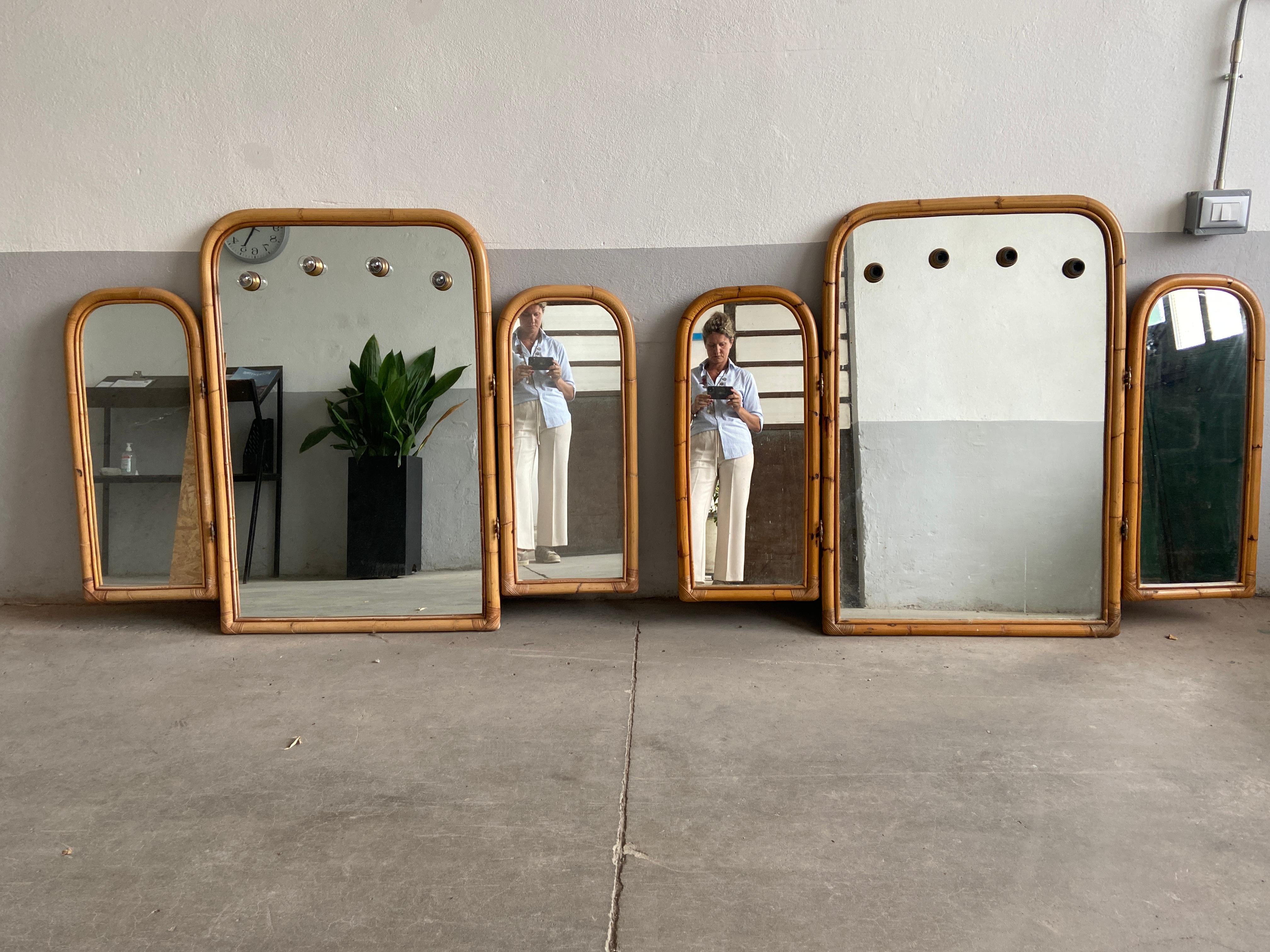 Mid-Century Modern pair of Italian triptych bamboo framed wall mirrors with 4-light in the main panel.
1970s
Measures for each mirror:
Central mirror panel cm 80 x 4 x H 122
Lateral mirror panels cm 40 x 4 x H 90 each.
   