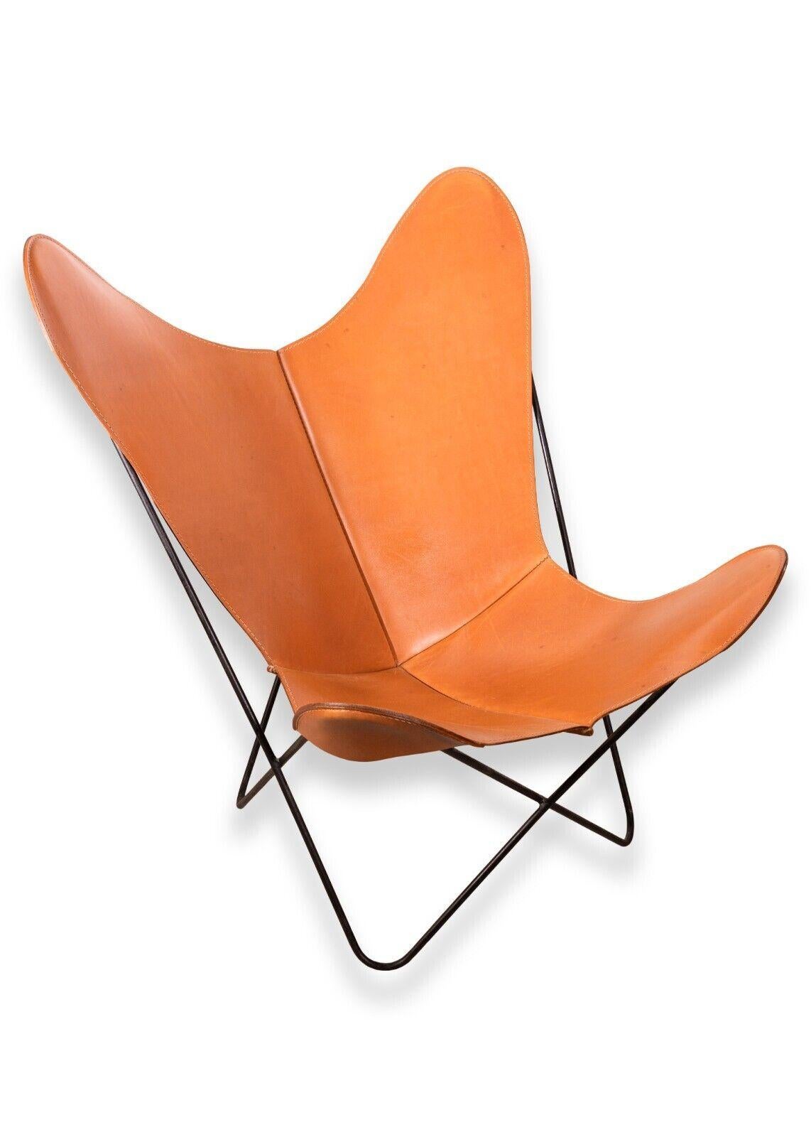 A pair of Knoll leather cognac butterfly chairs. A marvelous set of butterfly chairs from Knoll. These iconic chairs feature a rich cognac brown leather. The leather is in fantastic condition. It still sits very comfortably, and doesn't hold any bad