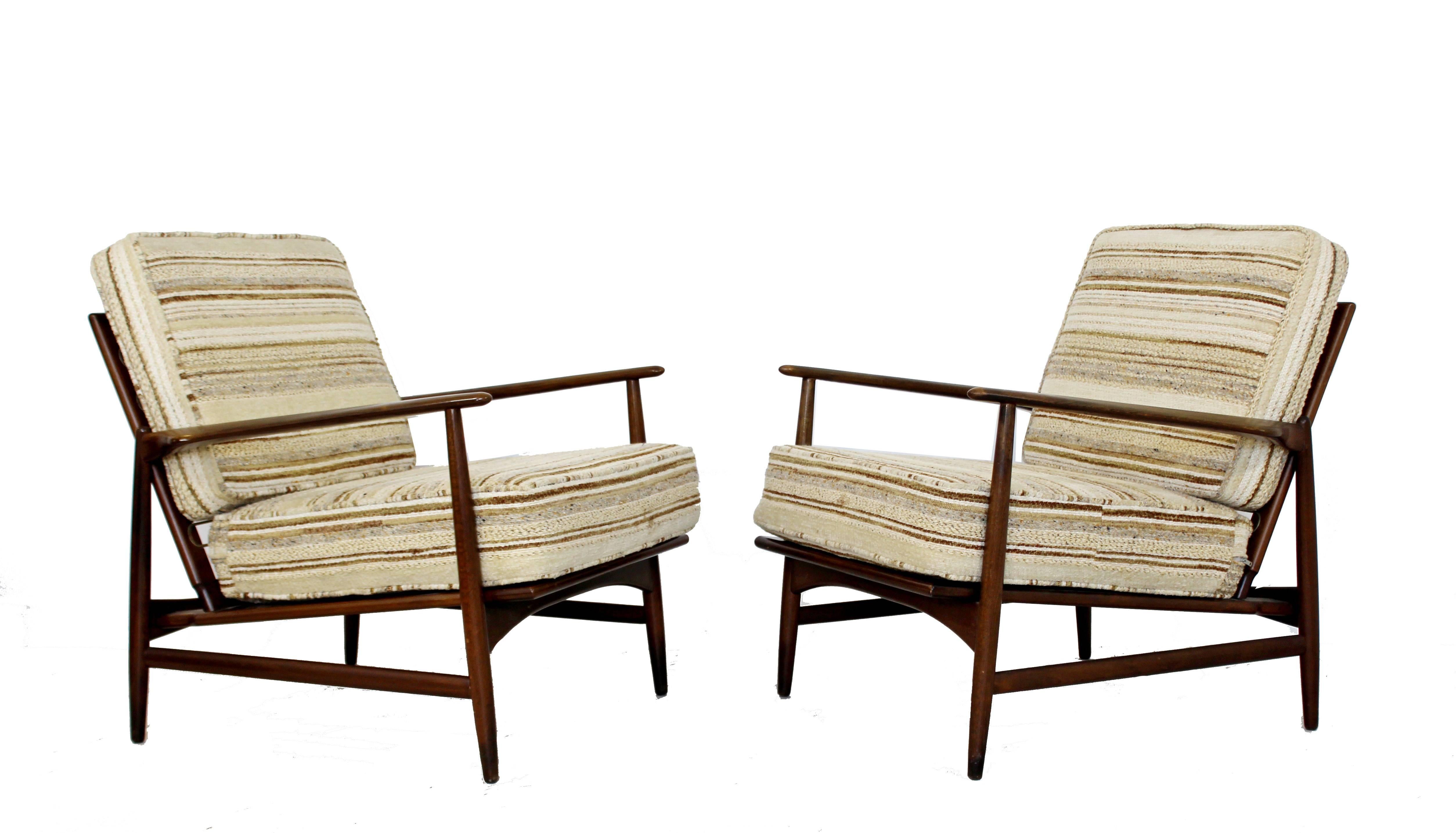 For your consideration is a stunning pair of lounge armchairs, with beautifully curved backs by Kofod-Larsen for Selig, made in Denmark, circa the 1960s. In excellent condition, new foam in the cushions. The dimensions of each chair are 29.5