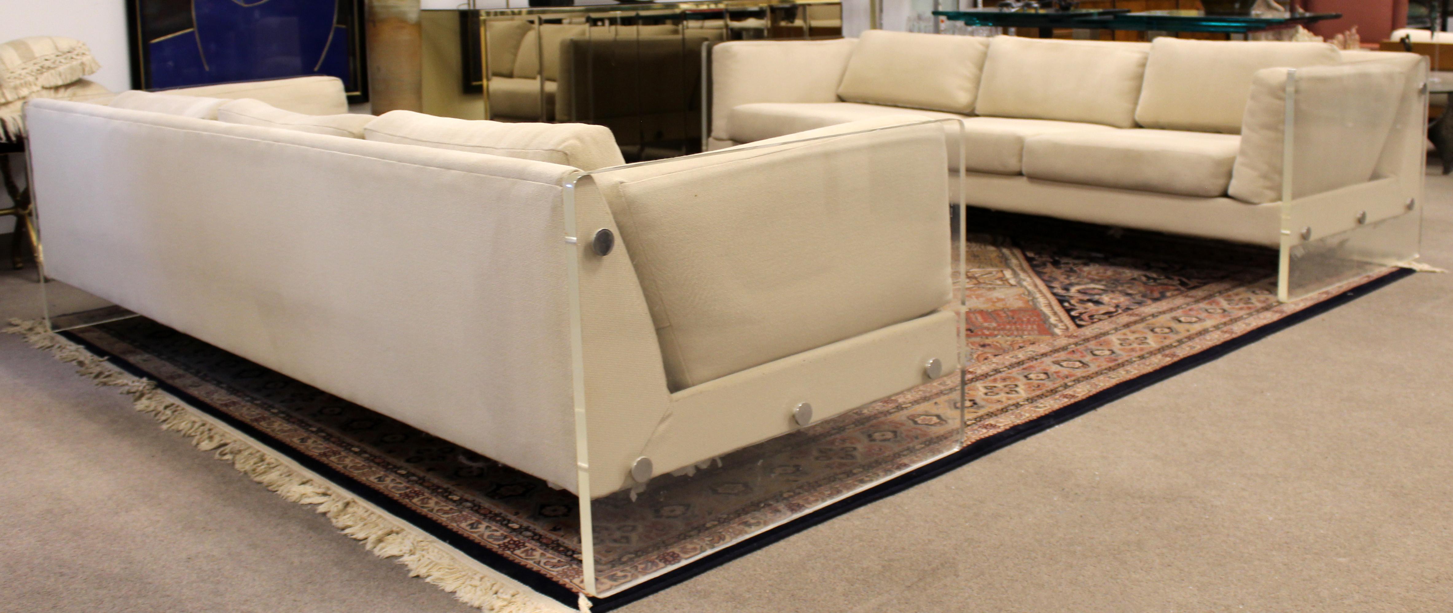 For your consideration is a pair of sensational sofas, with Lucite sides, in the Baughman, Selig style, circa 1970s . In very good vintage condition. The dimensions of each are 90.5