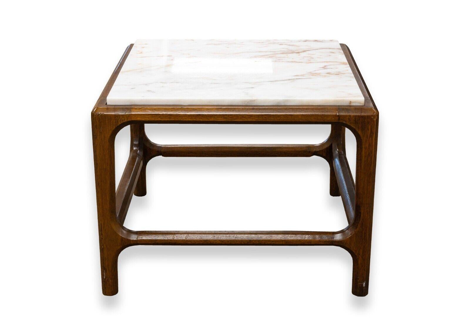 A pair of mid century modern mahogany wood and marble top side end tables. A stunning set of end tables featuring a rich mahogany wood frame with a gorgeous grain pattern, and a removable speckled marble top. This pair of tables are in very good