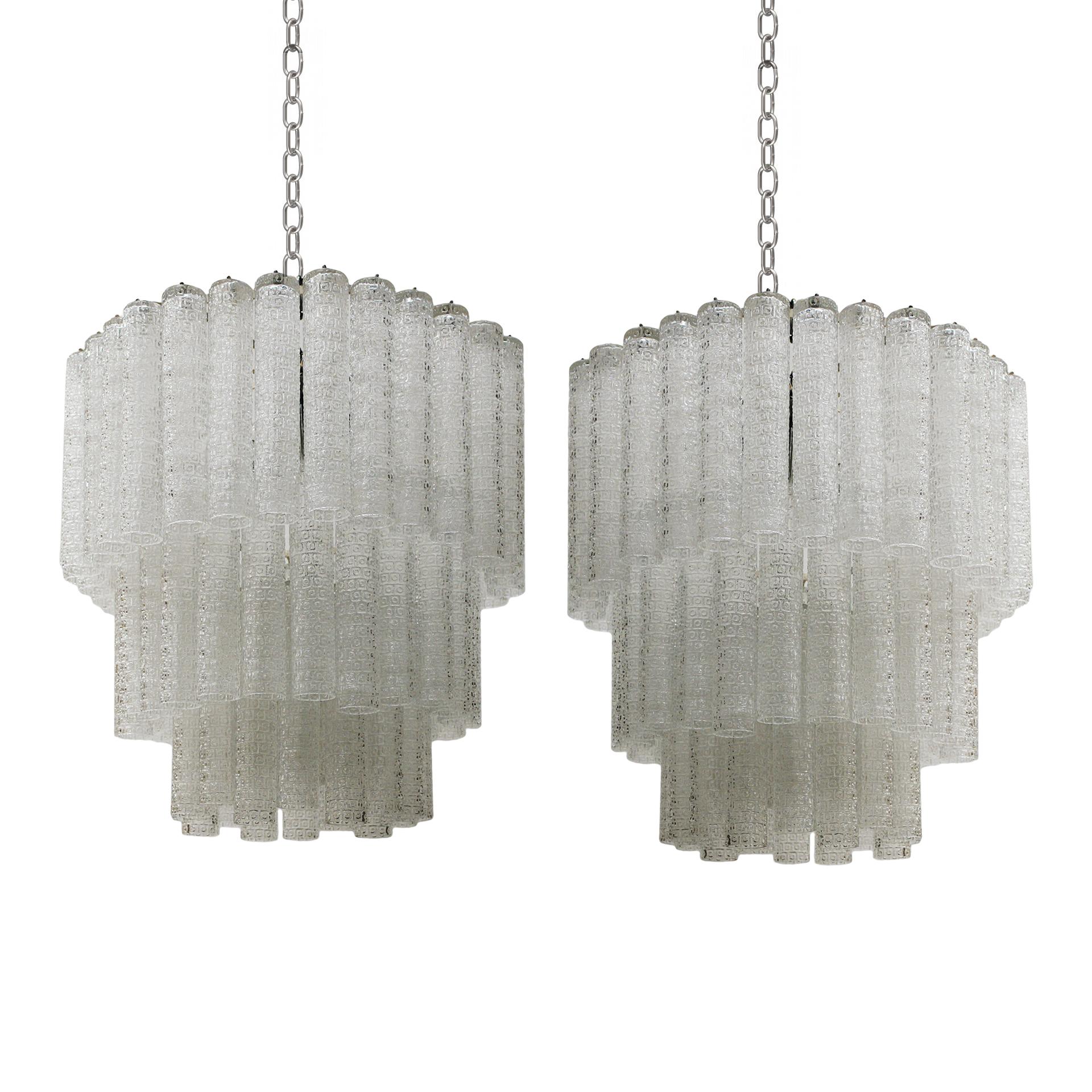 Pair of italian lamps edited by Venini. Composed of 5 light points and made of Murano glass. 1950s.

Introducing stunning mid-century-inspired lamps, handcrafted with molded glass, capturing the timeless beauty of the 1950s. These meticulously