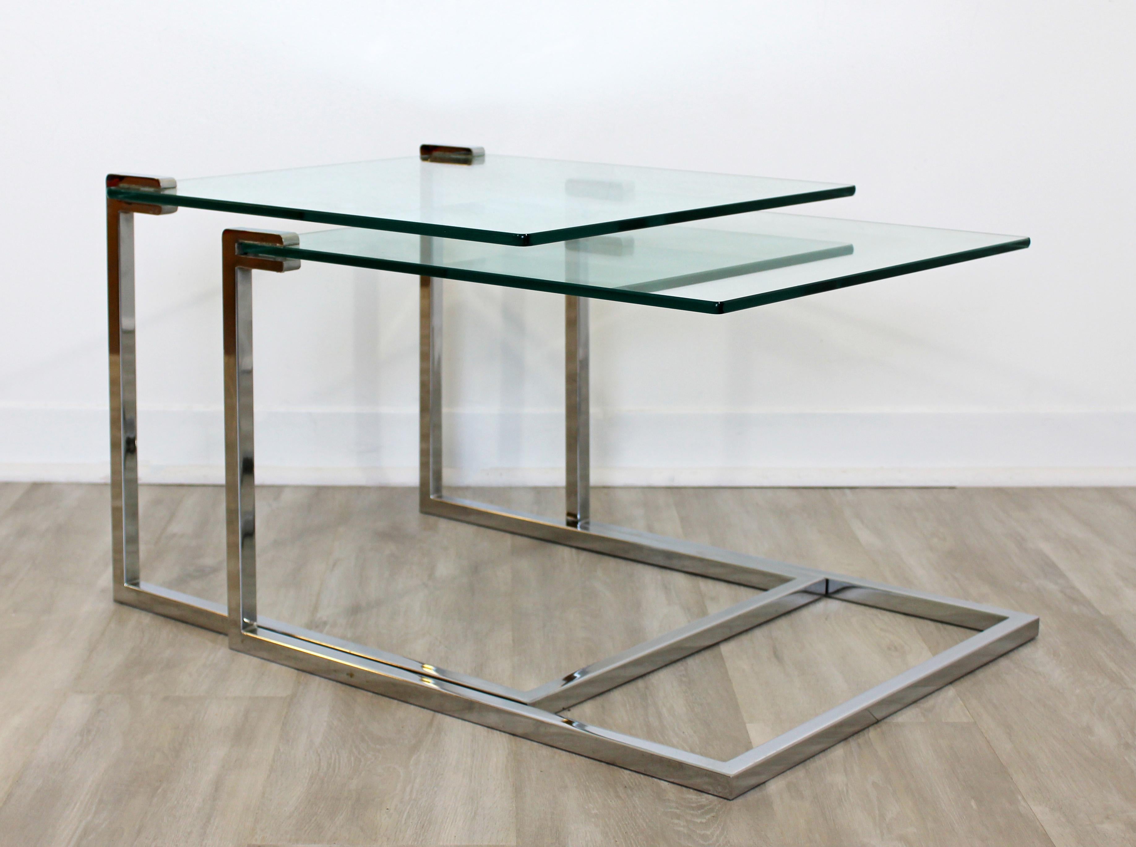 For your consideration is a simple and Classic pair of nesting tables, made of cantilevered chrome and with glass inserts, circa 1970s. In excellent vintage condition. The dimensions of both are 20