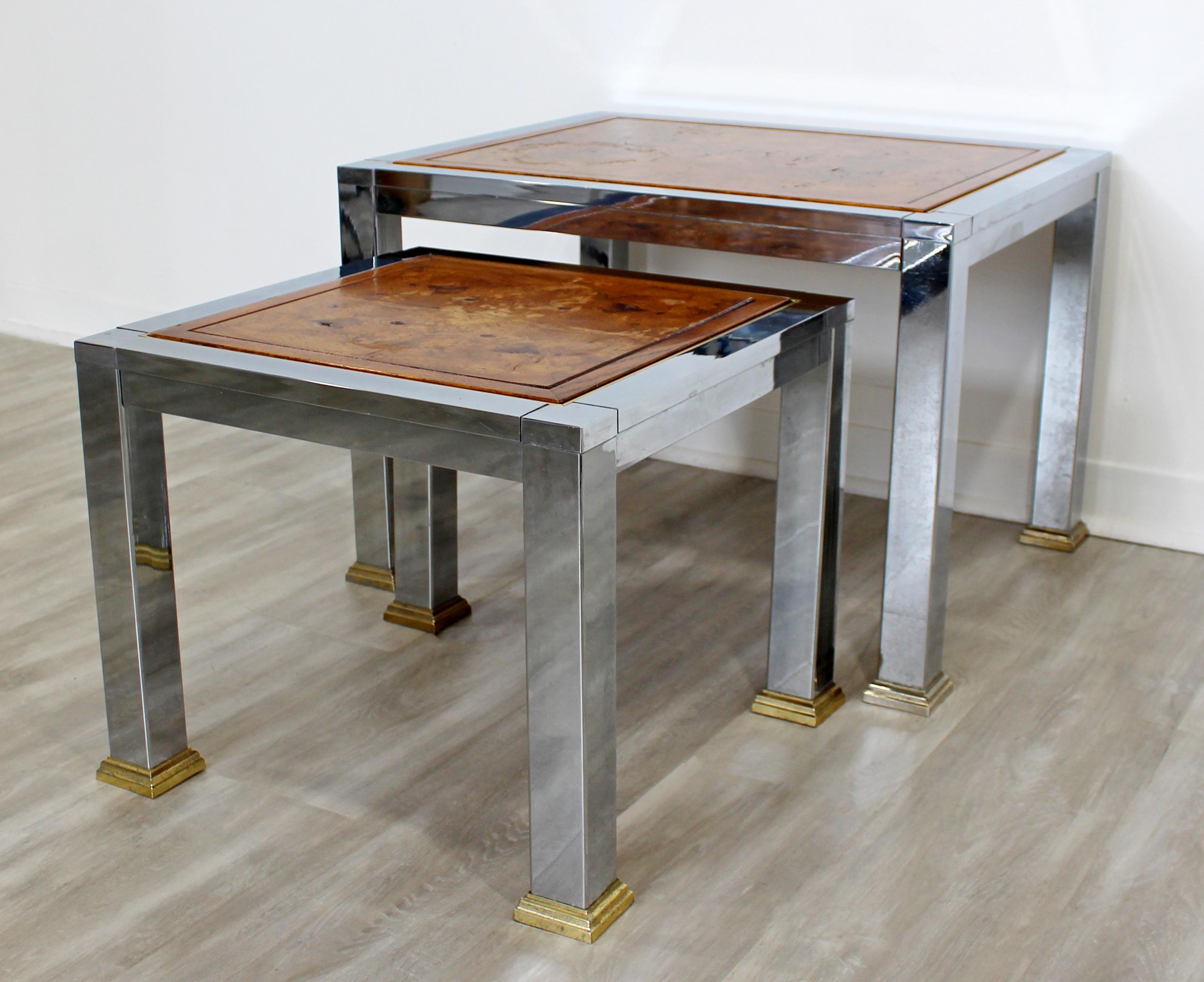 For your consideration is a stupendous pair of stacked nesting tables, made of chrome and brass and with burl wood top inserts, circa 1960s. In vintage condition. The dimensions are 27.5