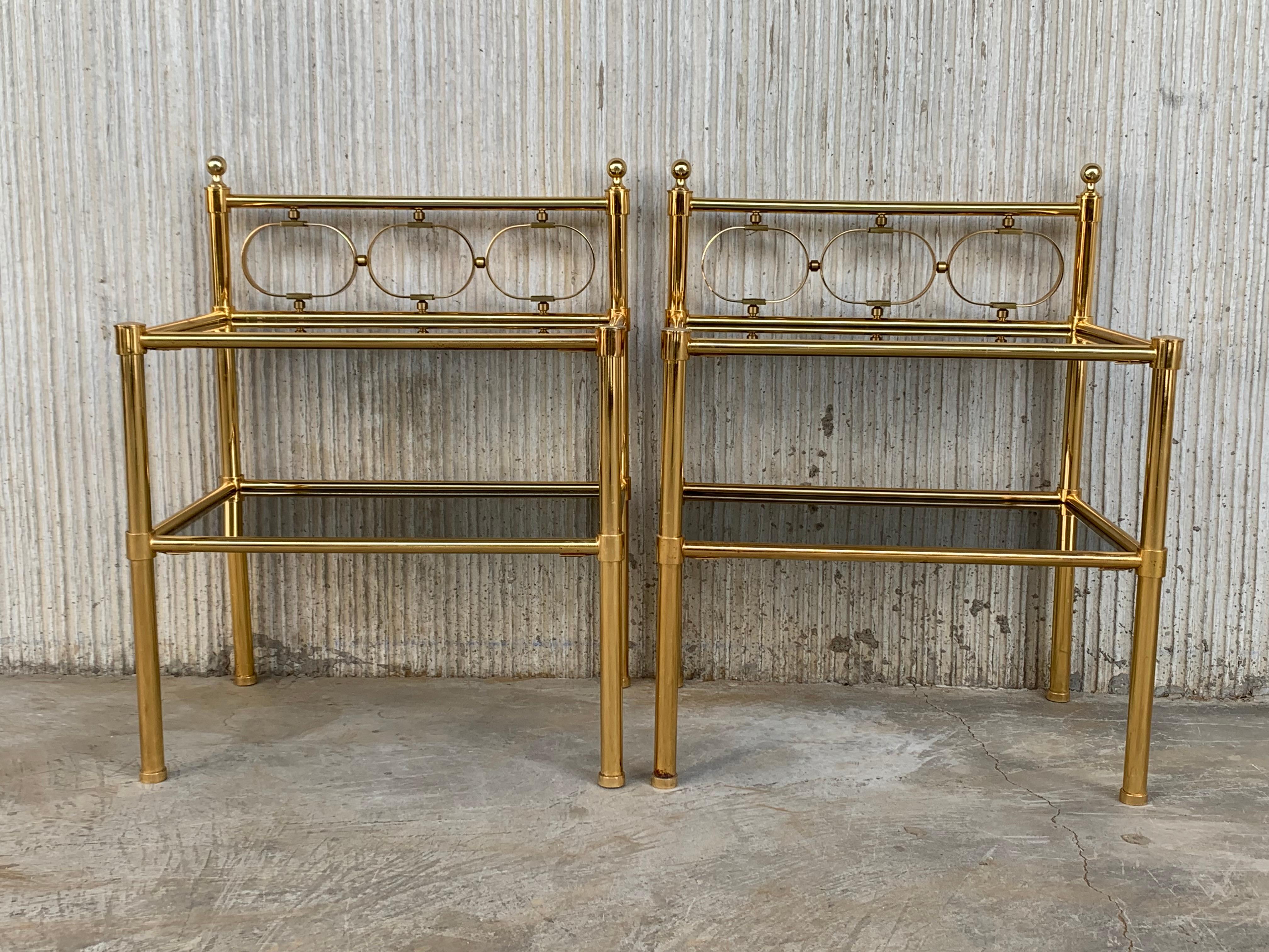 Mid-Century Modern pair of nightstands with two fumee glass shelves.

         