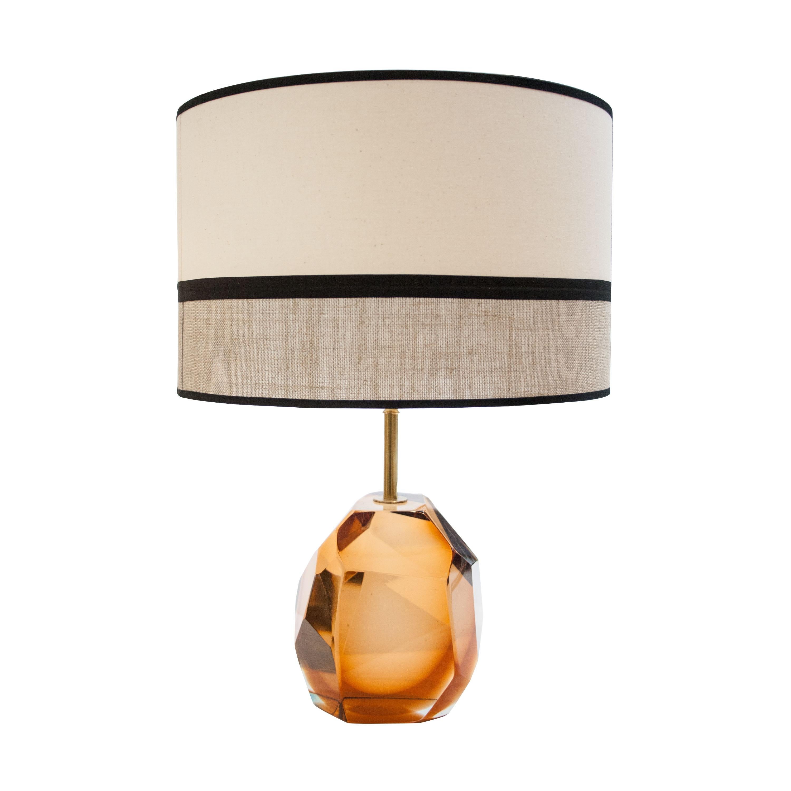 Pair of handmade table lamps made of orange Murano faceted glass in translucent orange with brass stem. Handmade lamp shade in black and two tones of beige.