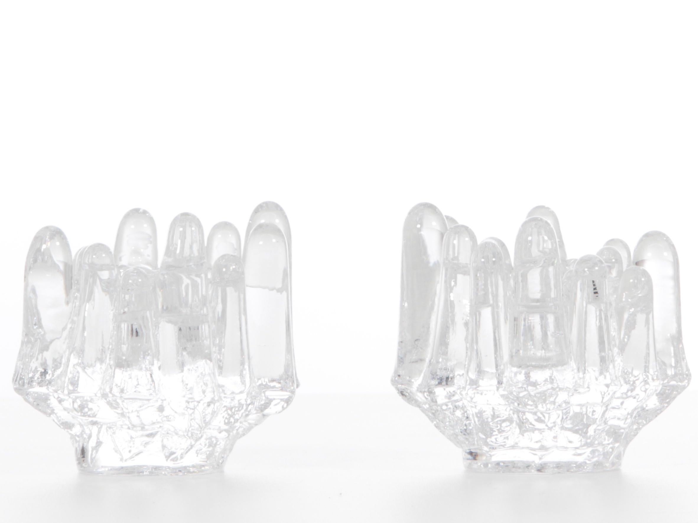 Pair of crystal polar candlesticks by Goran Warff for Costa Boda.

Polar candleholders are a Swedish Classic.
When Goran Warff created the Polar collection in the late sixties at Kosta Boda, he gave his candlesticks a form of ice block playing on