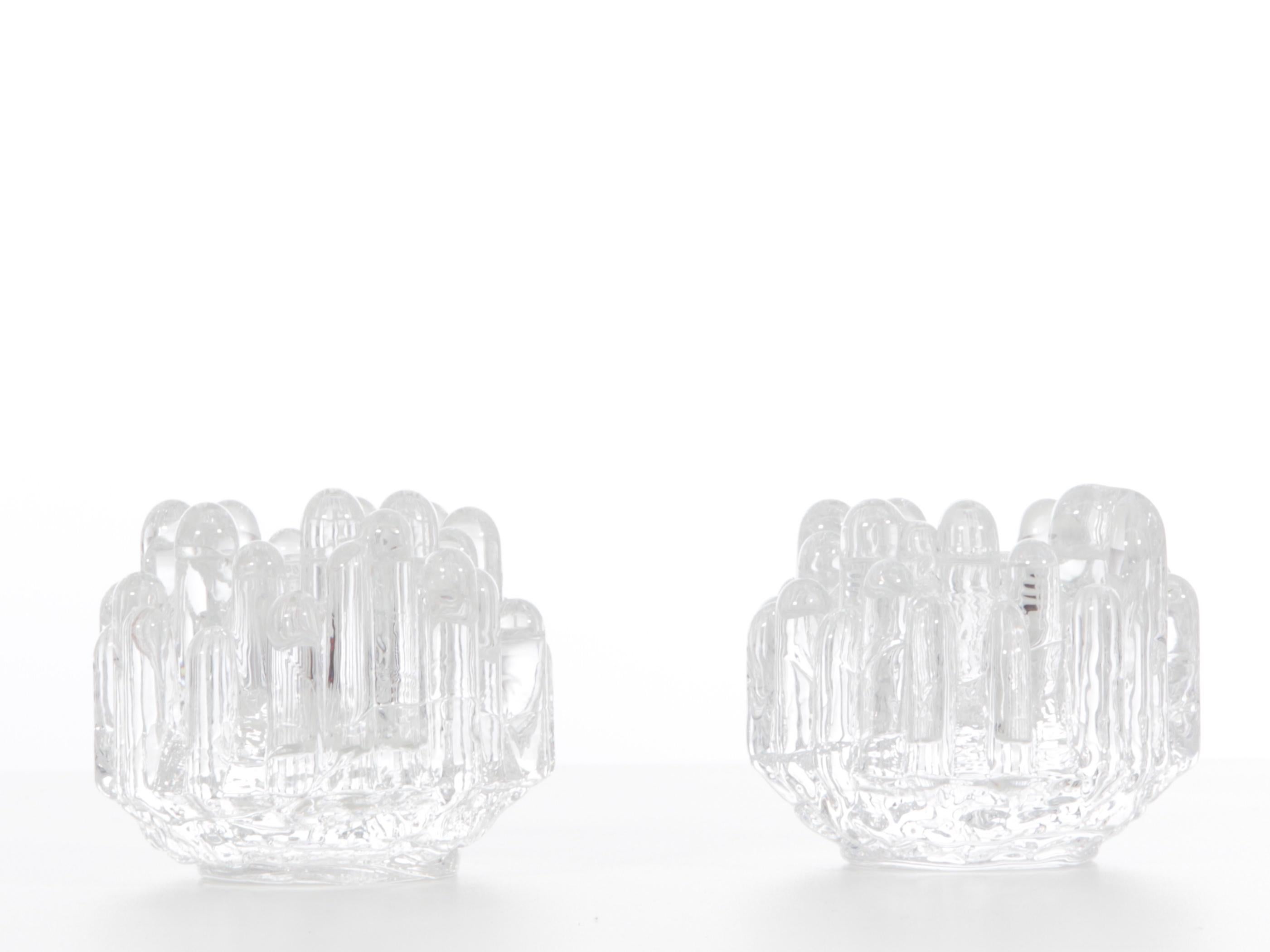 Pair of crystal Polar candlesticks by Goran Warff for Costa Boda.

Polar candleholders are a Swedish classic.
When Goran Warff created the Polar collection in the late sixties at Kosta Boda, he gave his candlesticks a form of ice block playing on
