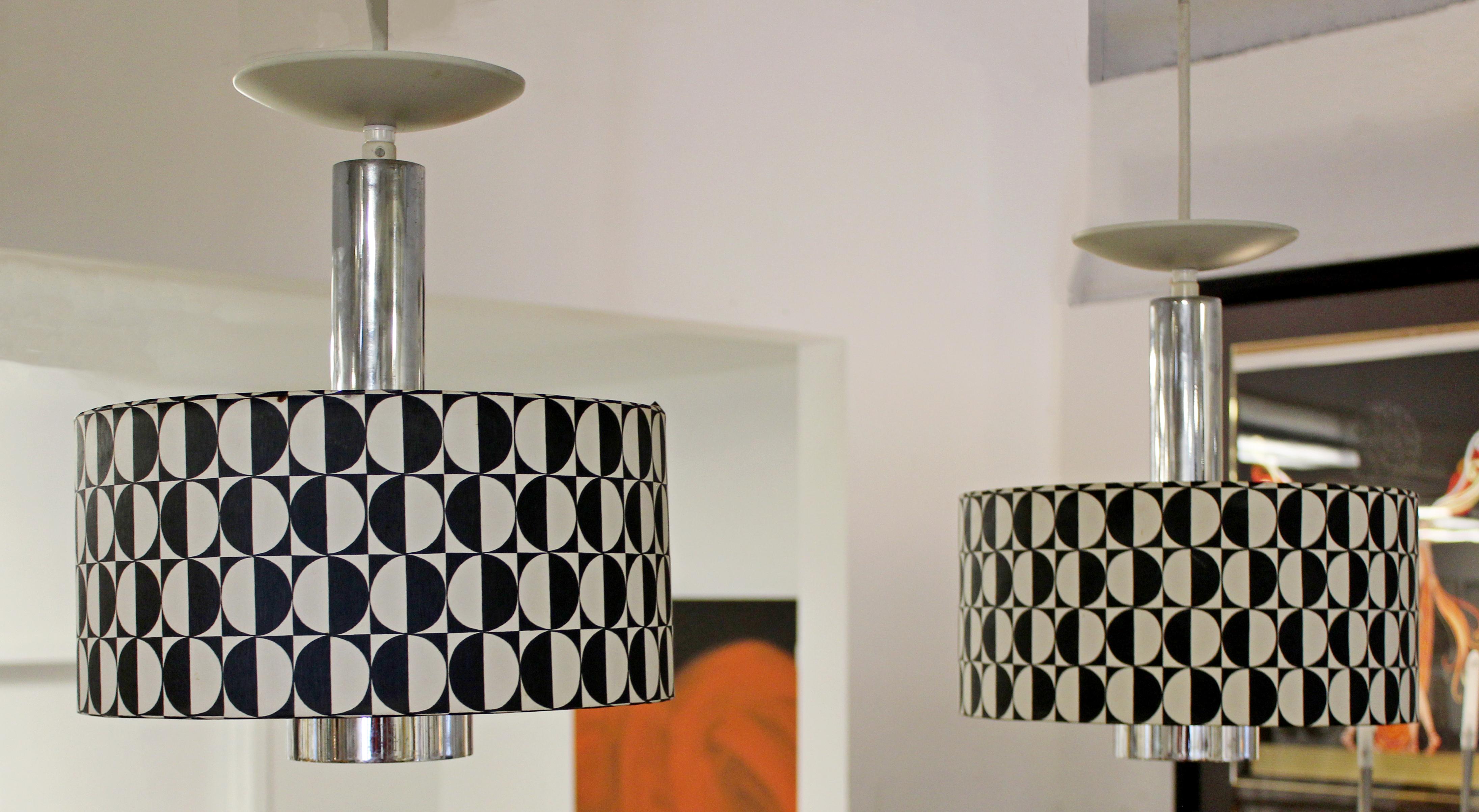 For your consideration is a rare pair of Italian, Lightolier, hanging light fixtures, circa 1960s. Acrylic and chrome globes with black and white shades. In very good condition. The dimensions are 12