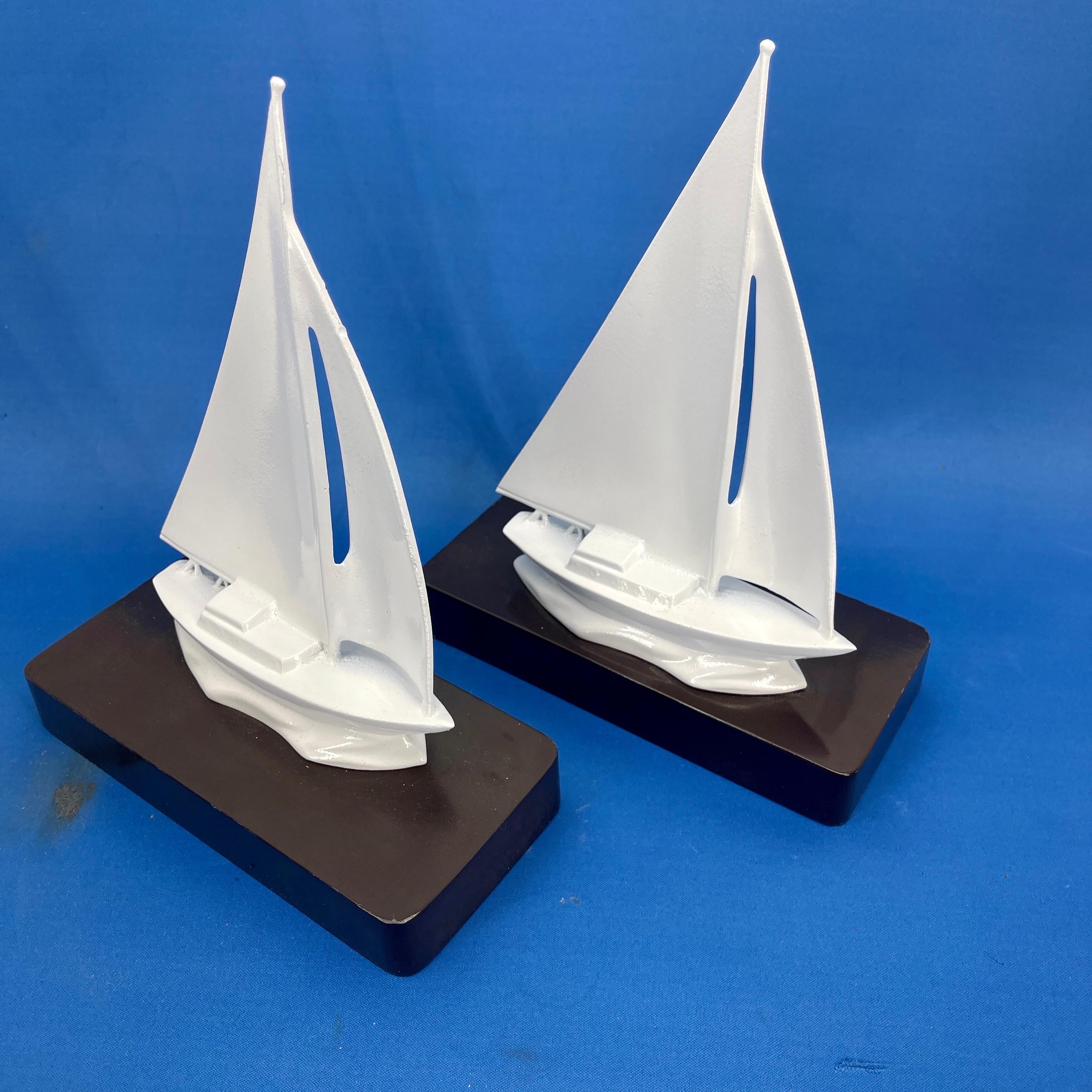 Powder-Coated Creamy White Set of Mid-Century Sailboat Bookends 

Substantial in size and weight, these solid vintage brass newly powder-coated boats are both form and function. Fabulous pair displayed on a bookshelf or desk or standing alone as