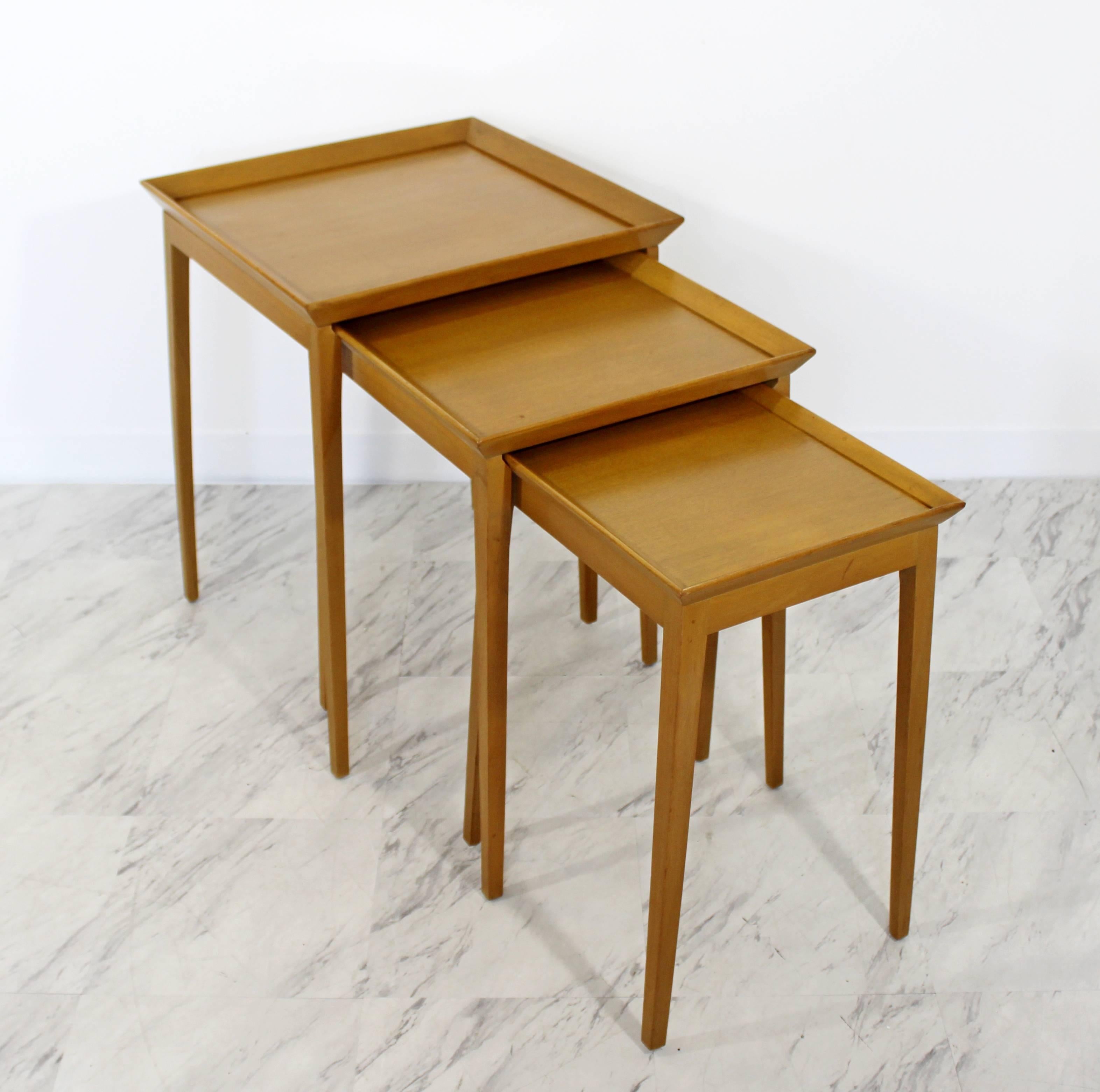 For your consideration is a fantastic pair of nesting table sets, both including three side tables that fit into one another, by T.H. Robsjohn-Gibbings for Widdicomb, circa the 1950s. In excellent condition. Both sets have the same dimensions, the