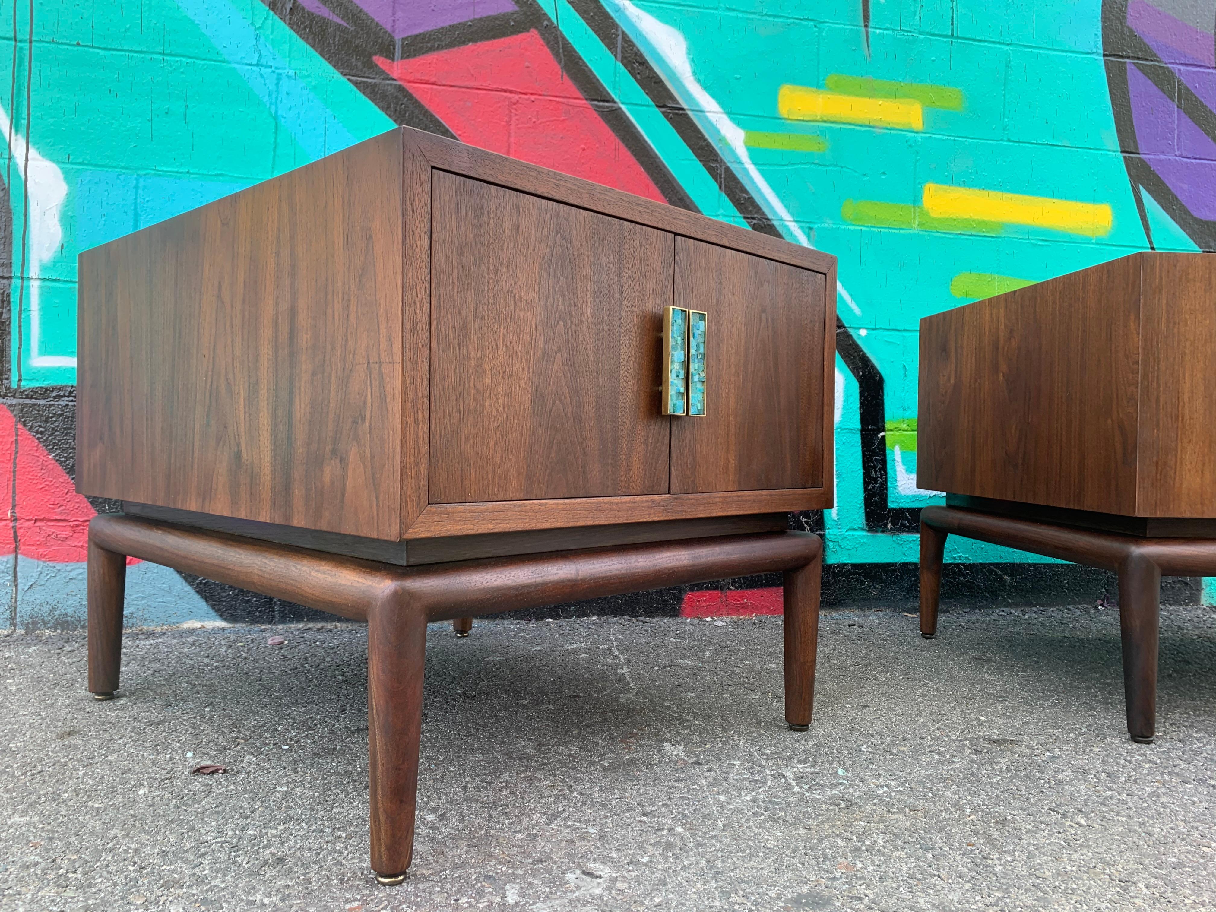 A pair of side tables or cabinets with two doors (push on magnetic lock system) with brass and tile pulls. Beautiful sculptural solid walnut wood base, USA, circa 1960s. Unmarked. Attributed to Cal Mode, Montevenrdi & Young.