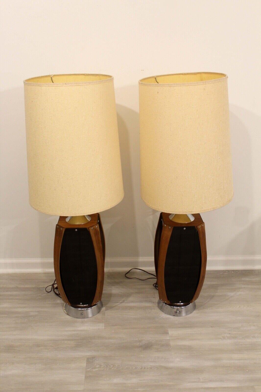 We presents a pair of 1970's funky wood and smoked glass table lamps. They also light up in the body of the lamp behind the smoked glass as shown in picture #9. In great condition. Dimensions: 17.5