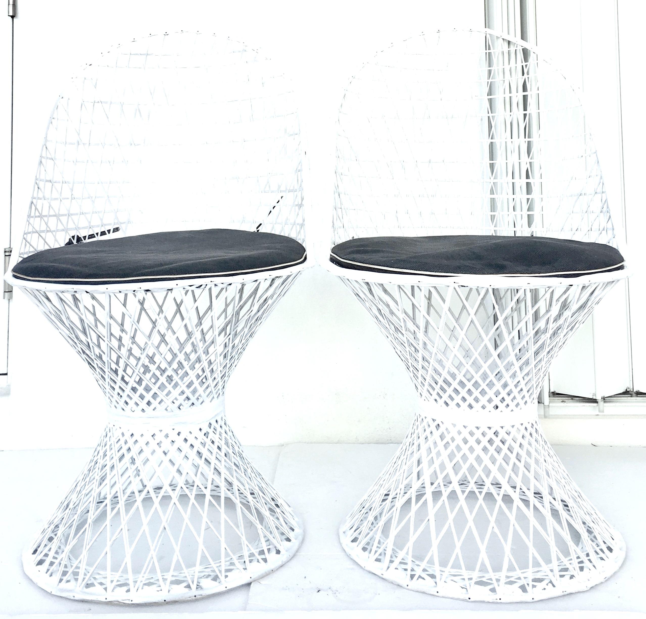 A Pair of spun fiberglass curve back chairs by Russell Woodard. Newly painted in original white finish. Includes two original black vinyl cushion with white piping. Ideal for any space, indoor or outdoor, lightweight for easy movement.
Measures: