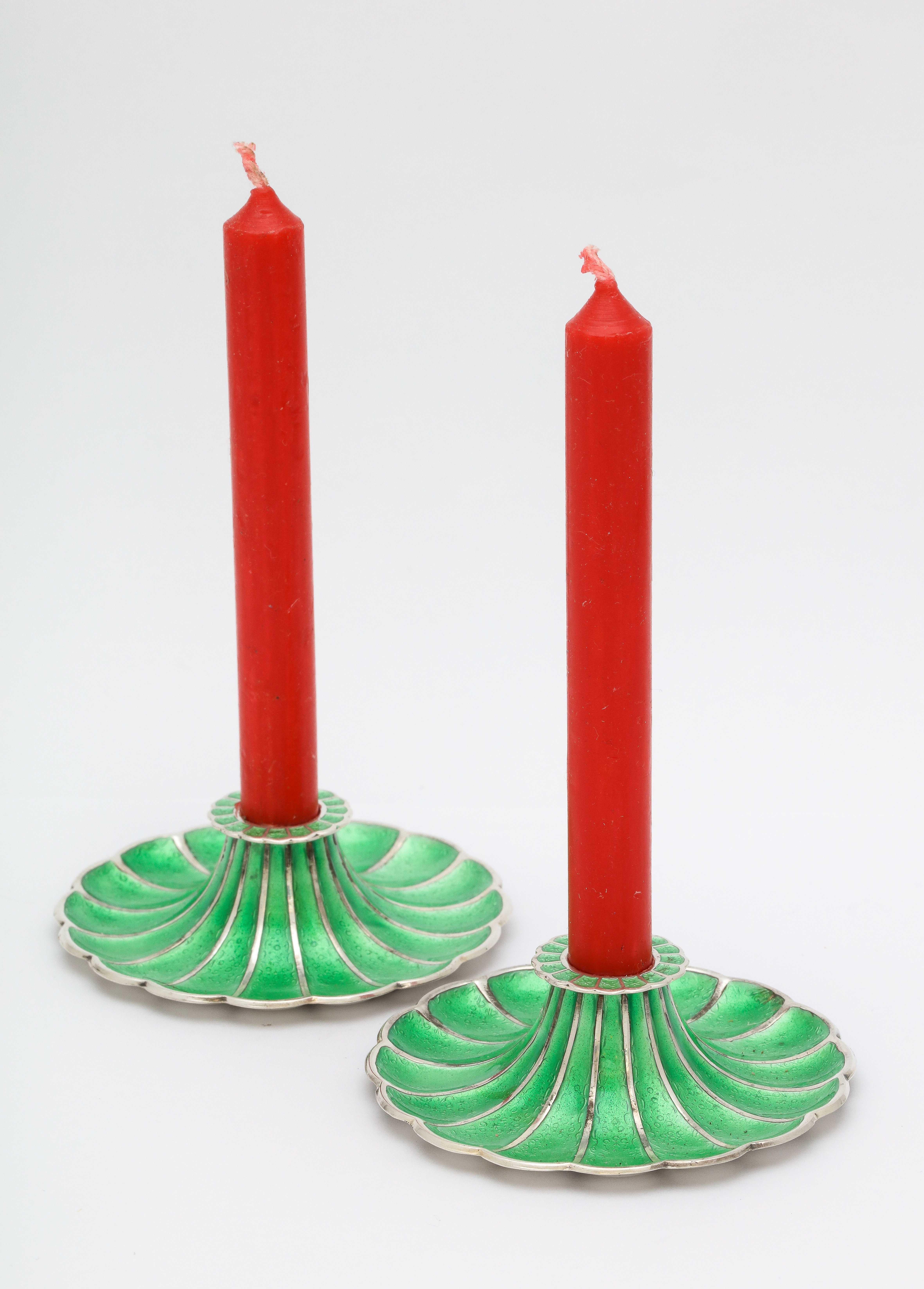 Mid-Century Modern pair of sterling silver and green enamel flower - form candlesticks, Denmark, circa 1960s, Meka of Holte - makers. Graceful design. Each measures 2 3/4 inches diameter x 1 inch high. Not weighted. The pair weighs 2.2 troy ounces.