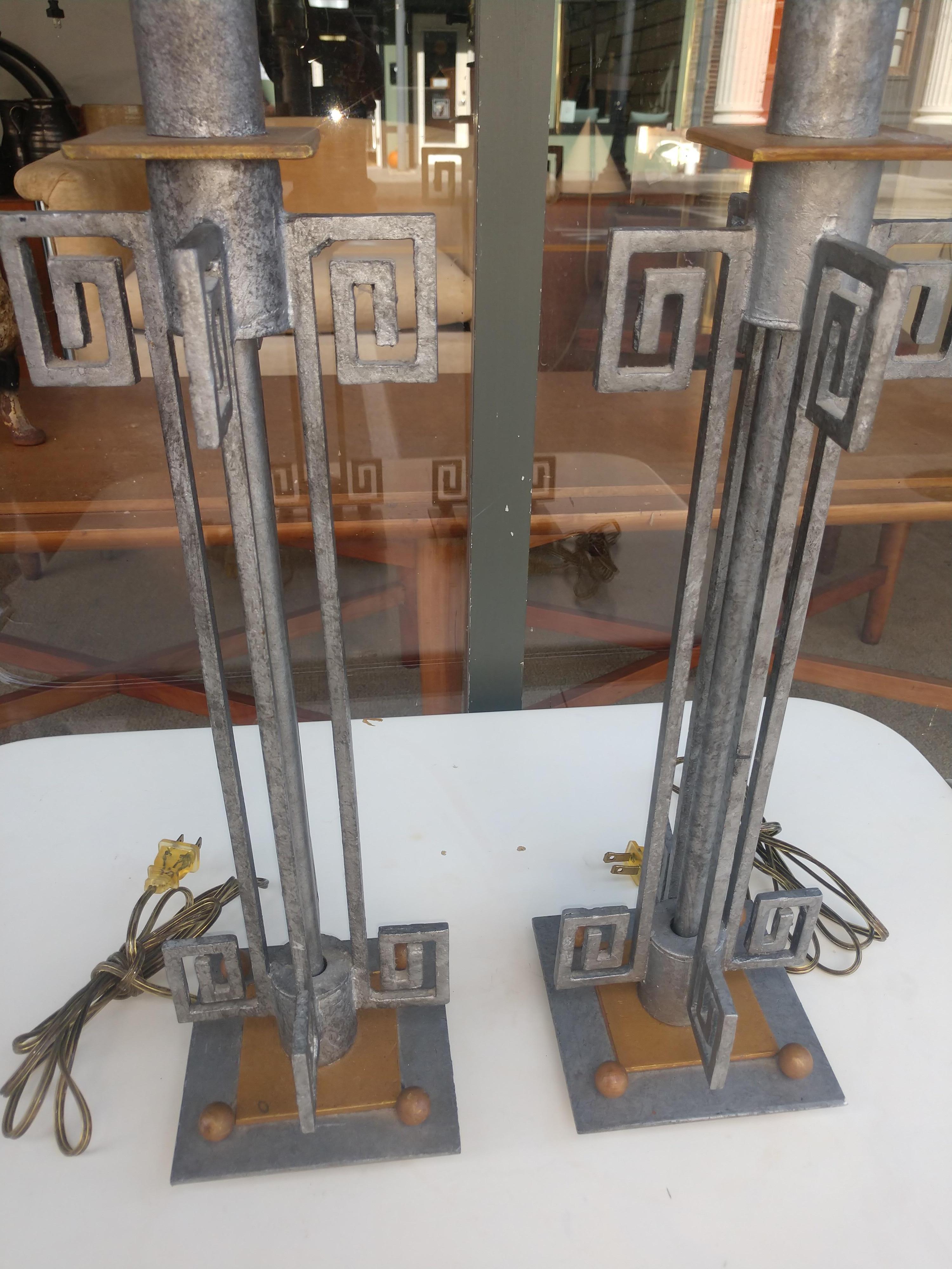 Fabulous pair of iron with brass mixed metal table lamps. C1965 with Greek Key Design, in excellent vintage condition with minimal wear. UL listed sticker present. 21 inch height to top of the socket, 27.25 to top of the shades. Shades not included.
