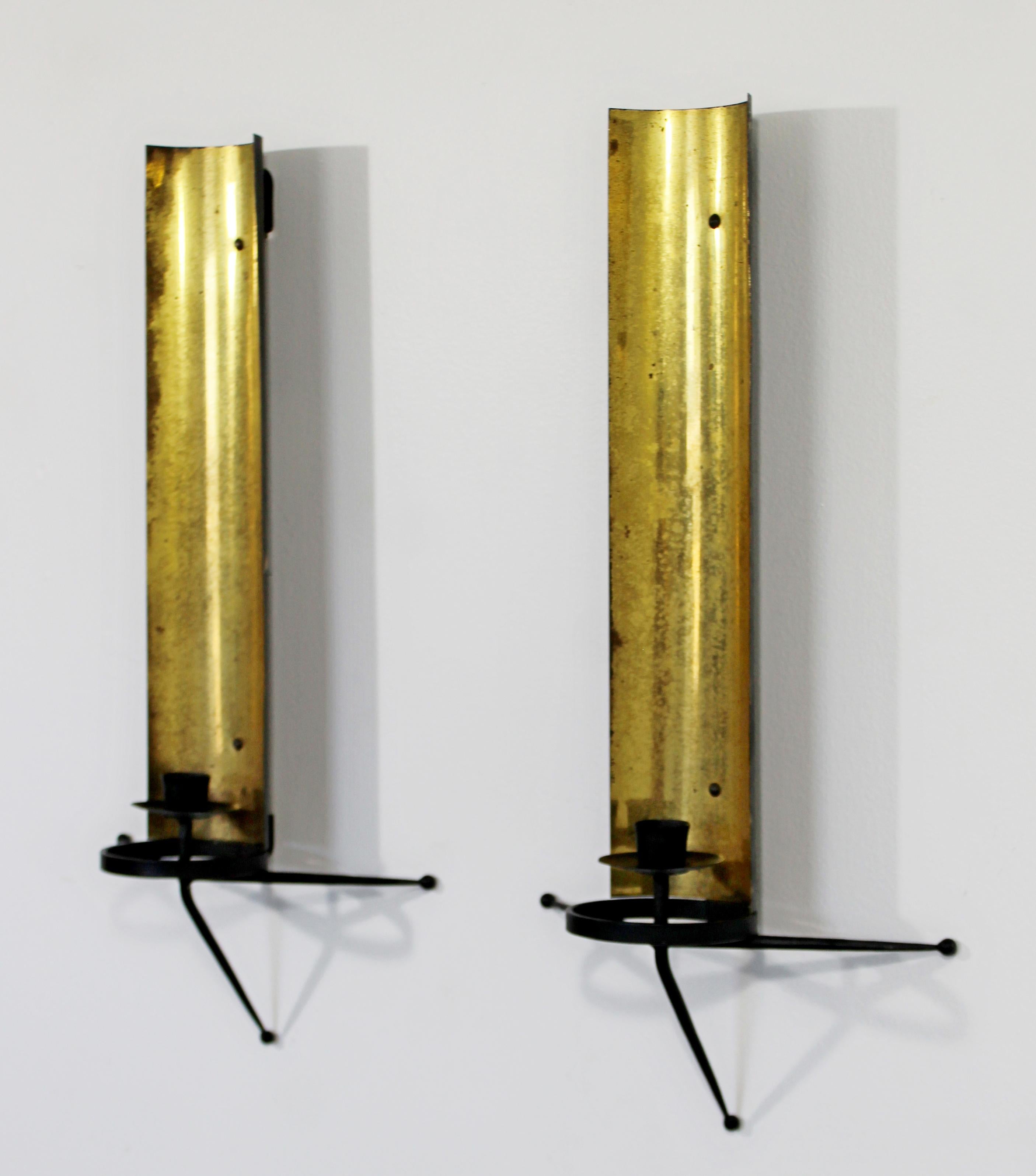 For your consideration is an incredible pair of brass and black metal wall sconces, by Tony Paul, circa 1950s. In very good vintage condition. The dimensions of each are 9