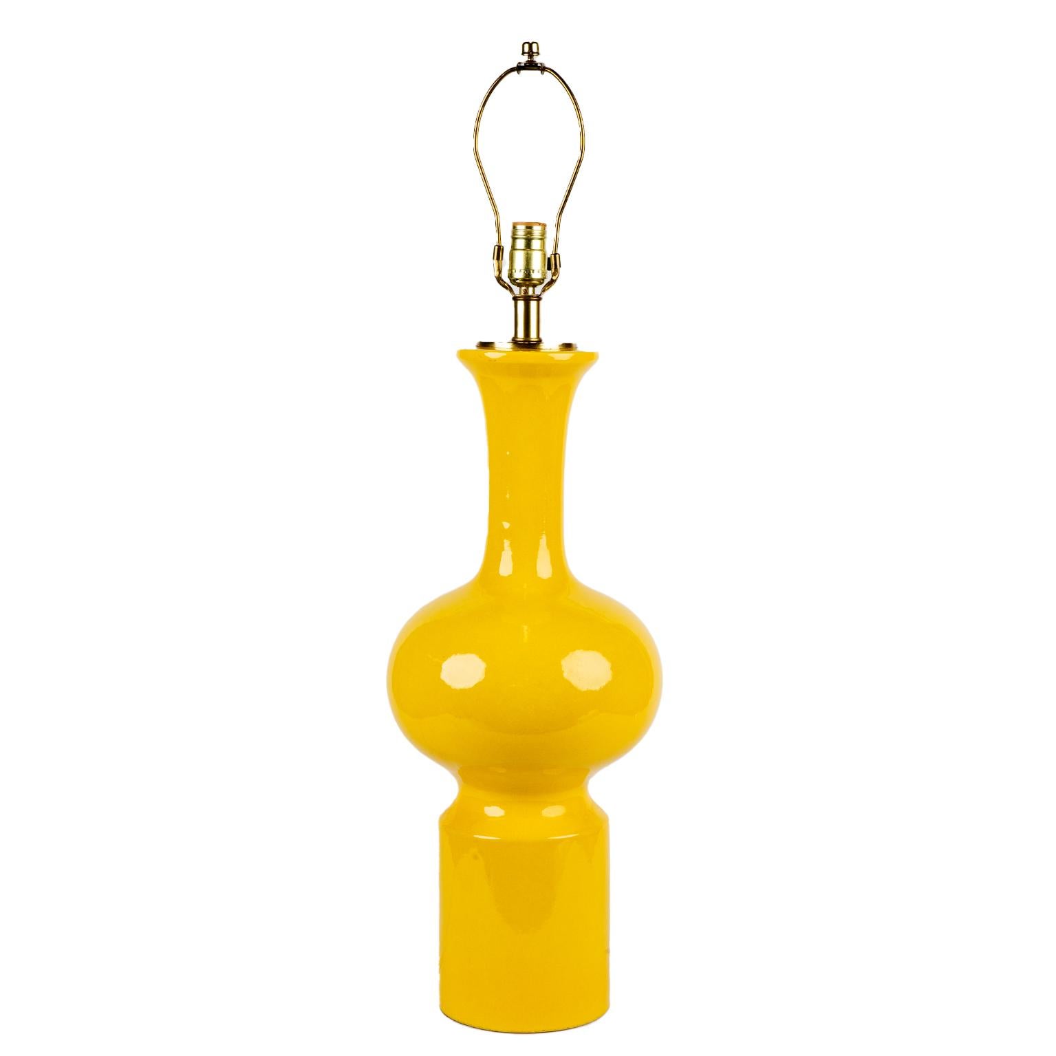 A striking and tall pair of canary yellow glazed mid century modern ceramic lamps. This bold pair are in excellent vintage condition and date from the early 1970’s. The base height is 23.5