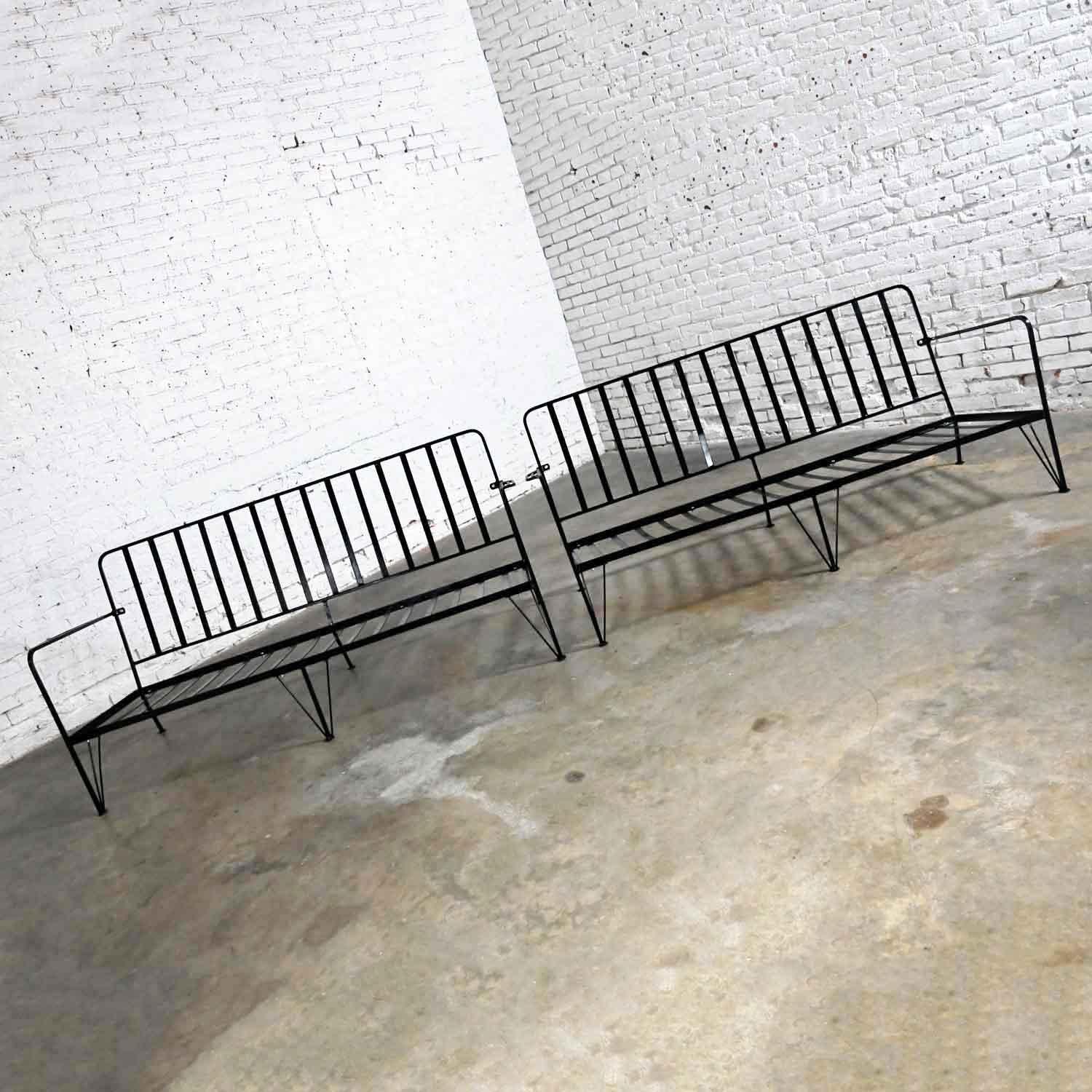 Fabulous vintage Mid-Century Modern pair of black painted wrought iron outdoor settees. These are frames only. You will need to buy or have cushions made. Beautiful condition, keeping in mind that these are vintage and not new so will have signs of