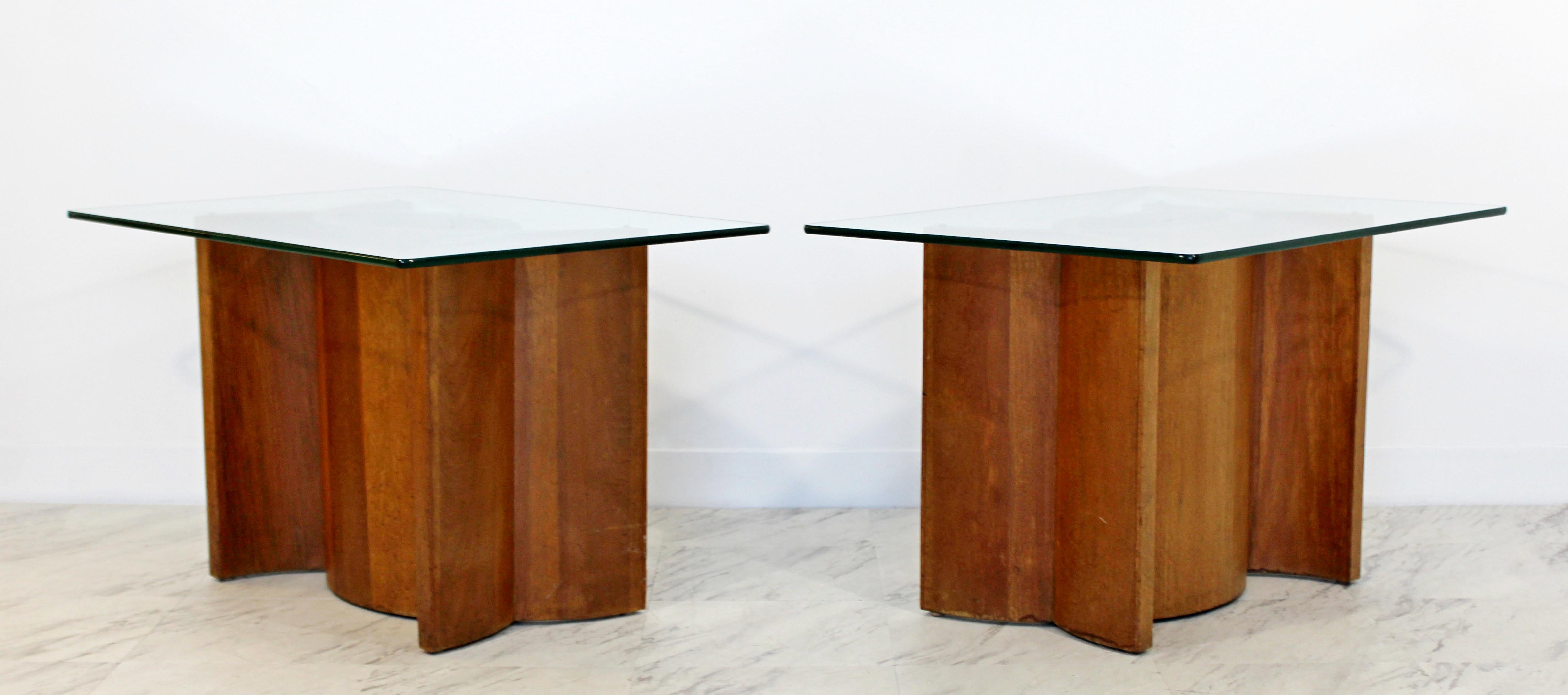 For your consideration is a gorgeous pair of side or end table, with unique sculptural walnut wood bases and rectangular glass tops. In good condition. The dimensions are 22