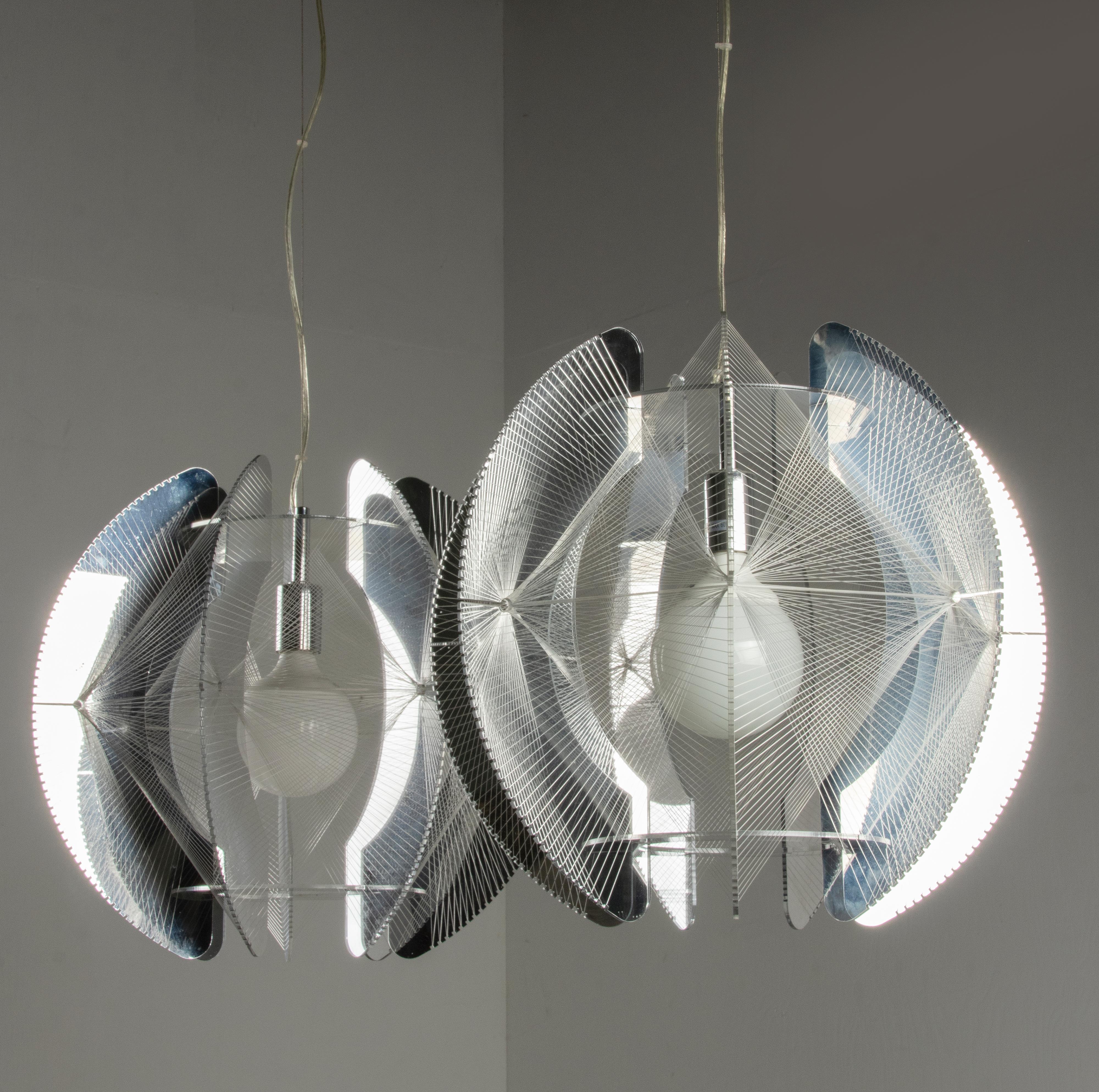 A pair of Mid-Century Modern pendant lamps, design by Paul Secon and produced by Sompex. Made of chrome acrylic slats wound with nylon thread. It gives a warm light when lit. When smithed on, the chromed look slants gives nice ambient sphere. A