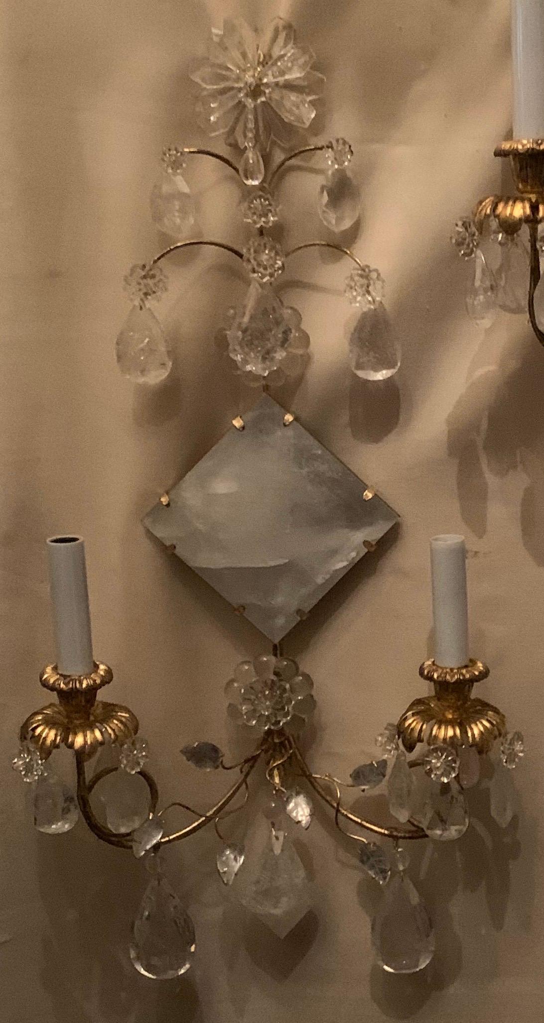 A wonderful Mid-Century Modern pair of transitional gold leaf and rock crystal diamond center medallion sconces with two candelabra lights adorned with flowers and beads, rewired and ready to enjoy.