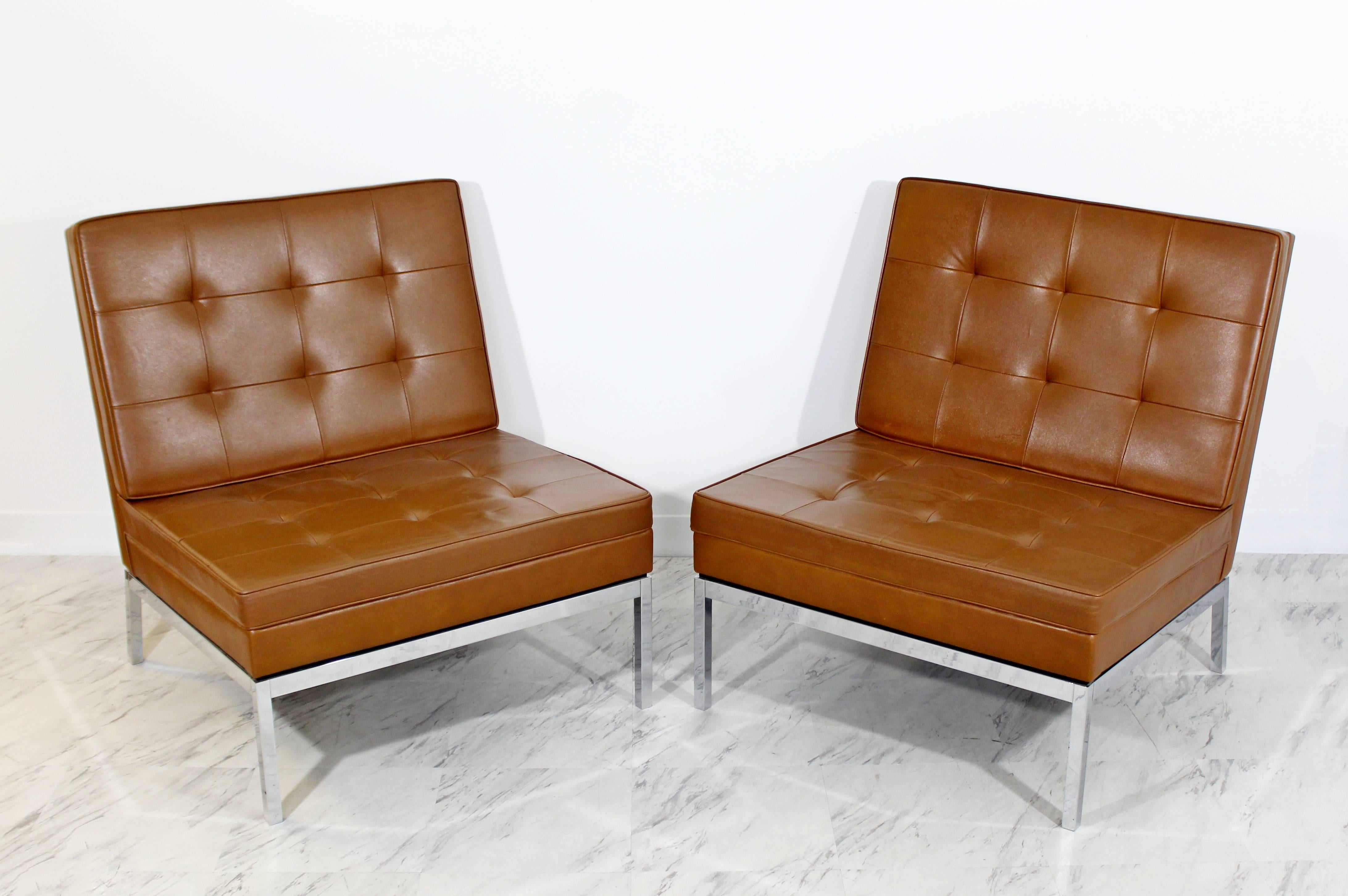 For your consideration is a phenomenal pair of chrome and brown leather slipper chairs, model #65, by Florence Knoll, circa 1960s. In excellent condition. The dimensions of each are 28