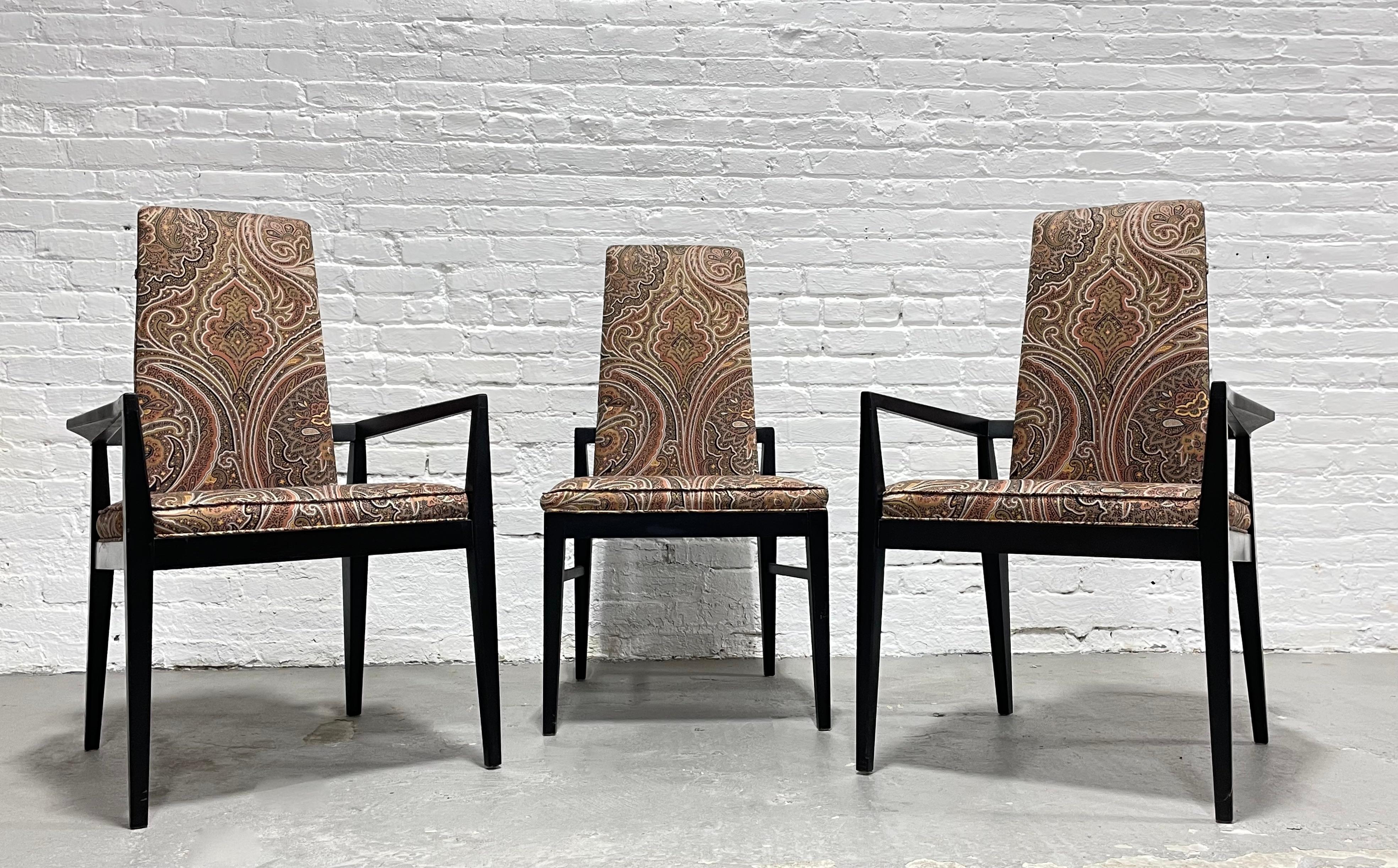Incredible set of three Mid-Century Modern ebonized chairs in the most perfect paisley upholstery. The backs are framed out and absolutely lovely with black frames and gorgeous design. These chairs are showstoppers and would be perfect as captain