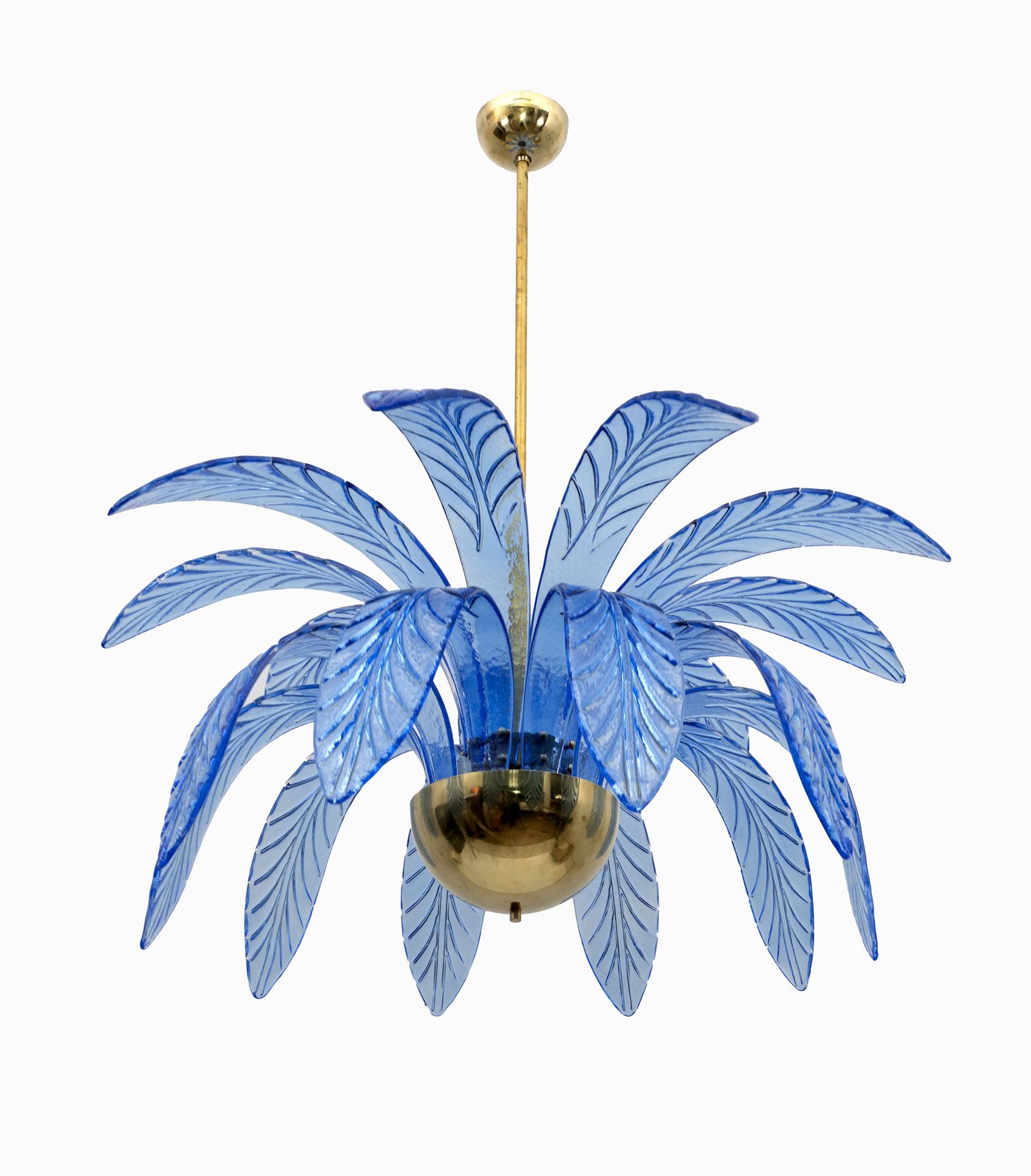 Mouth-blown Murano glass chandelier, light blue Murano glass leaves, brass structure, three light bulbs. The chandelier reproduces the crown of a palm tree. We supply reducers for E12 USA bulbs.