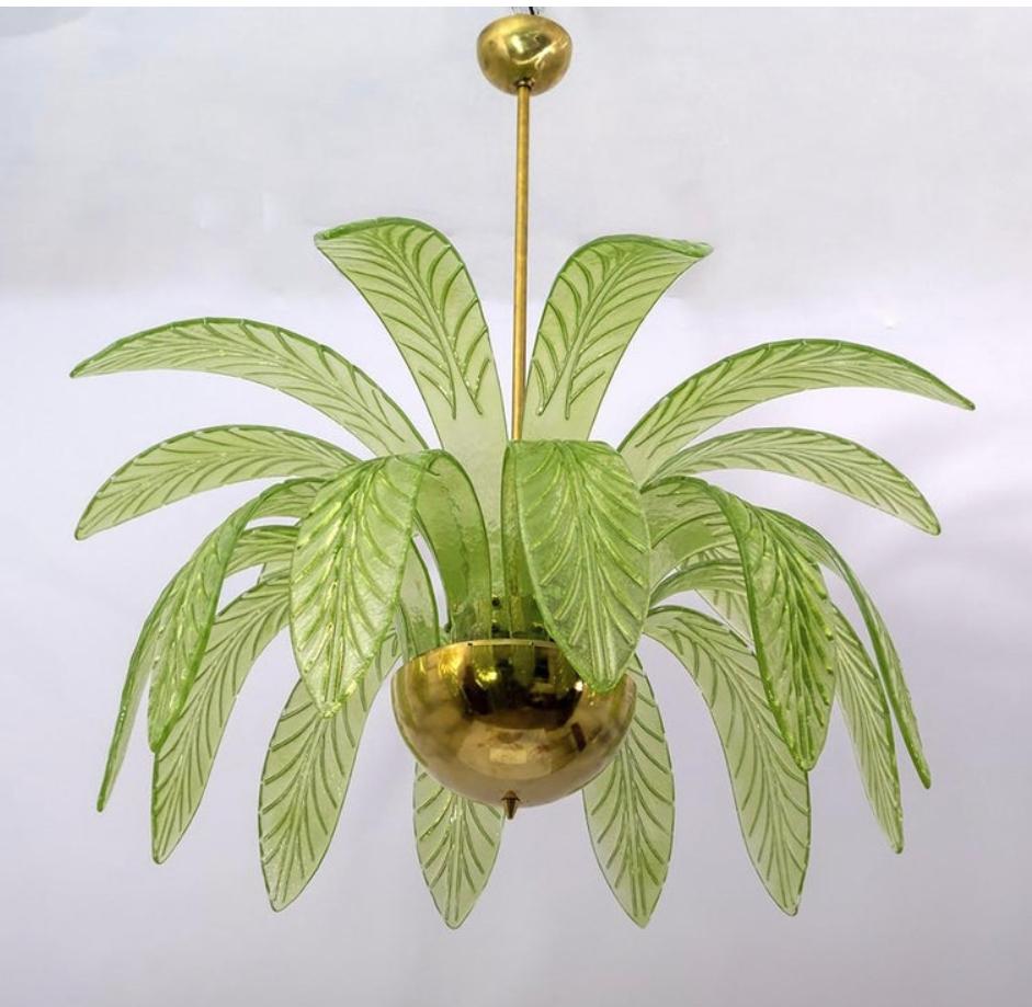 Mouth blown Murano glass chandelier, green Murano glass leaves, brass structure, three bulbs.
The chandelier reproduces the crown of a palm tree.
We supply reducers for USA E12 bulbs.