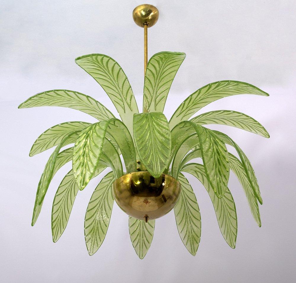 Mouth-blown Murano glass chandelier, green Murano glass leaves, brass structure, three light bulbs. The chandelier reproduces the crown of a palm tree. We supply reducers for E12 USA bulbs.