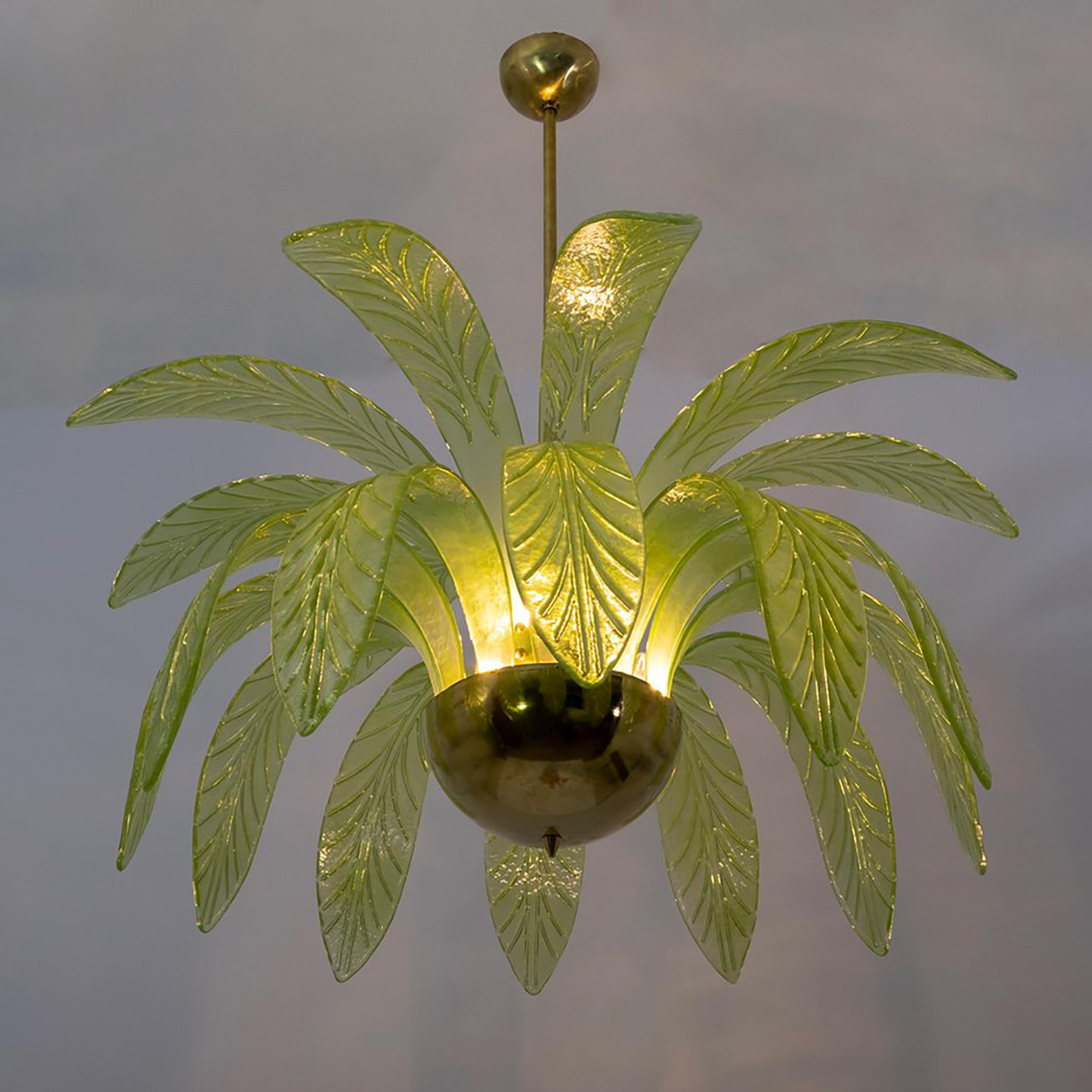 Mouth blown Murano glass chandelier, green Murano glass leaves, brass frame, three light bulbs. The chandelier reproduces the crown of a palm tree. Rewired to European and US standards, equipped with E14 or E12 lamp holder.