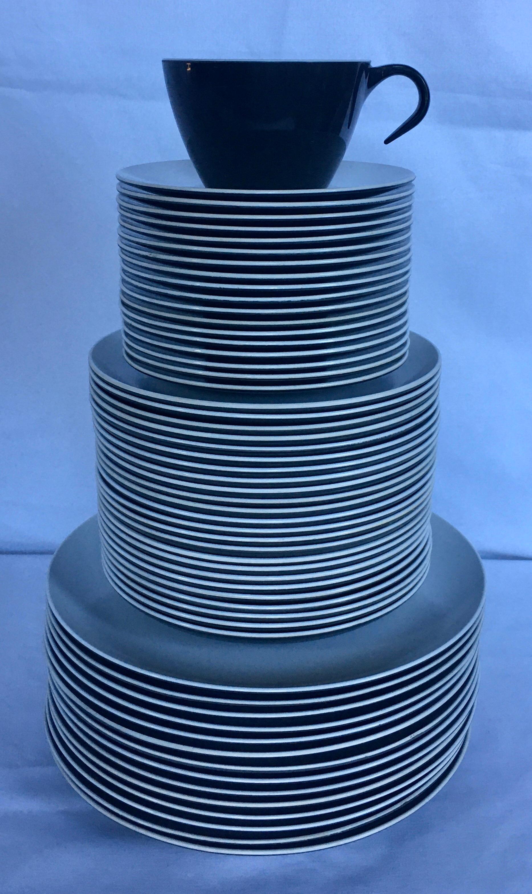 Mid-Century Modern pan Am American Airlines black/charcoal and white 74 piece melamine dinnerware service. Set includes 14 large plates, 24 small plates, 18 cups, and 18 saucers. Dated 1967.

14 large plates: 8.25in diameter.
24 small plates: 6.25in