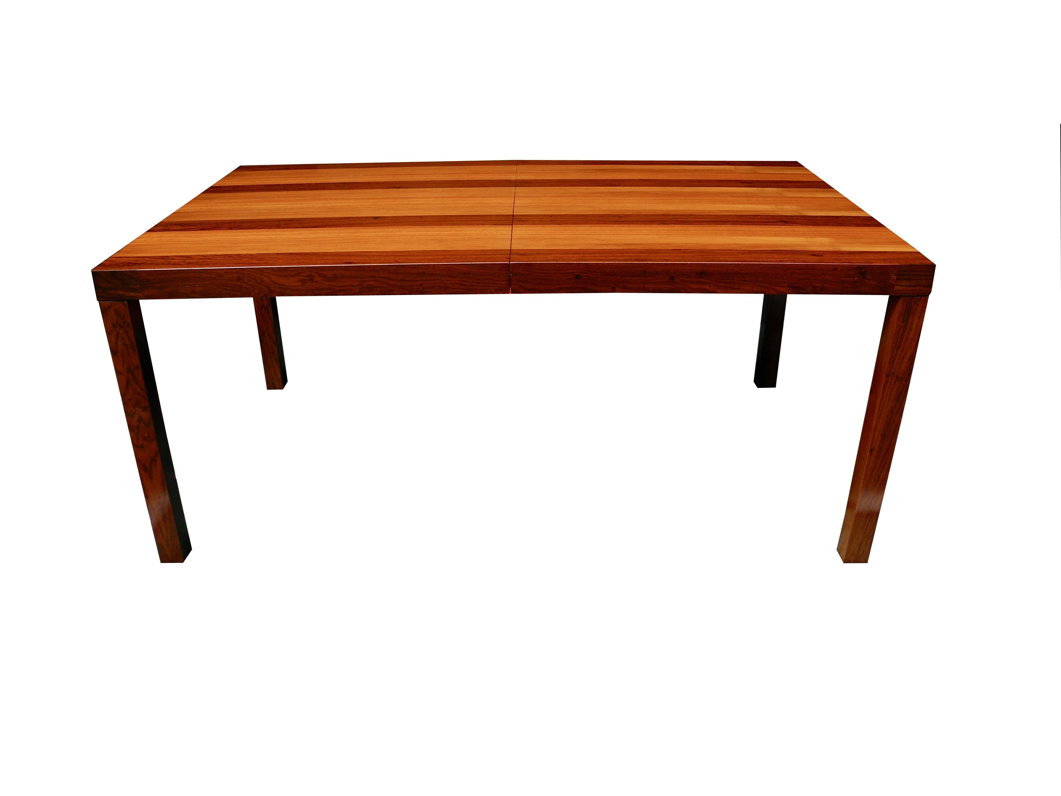 Newly refinished to bring out the natural woods, this parson table has an extra leaf 23.5 inches wide to extend the table. The leaf matches perfectly. Designed by Milo Baughman in rosewood, walnut and teak.