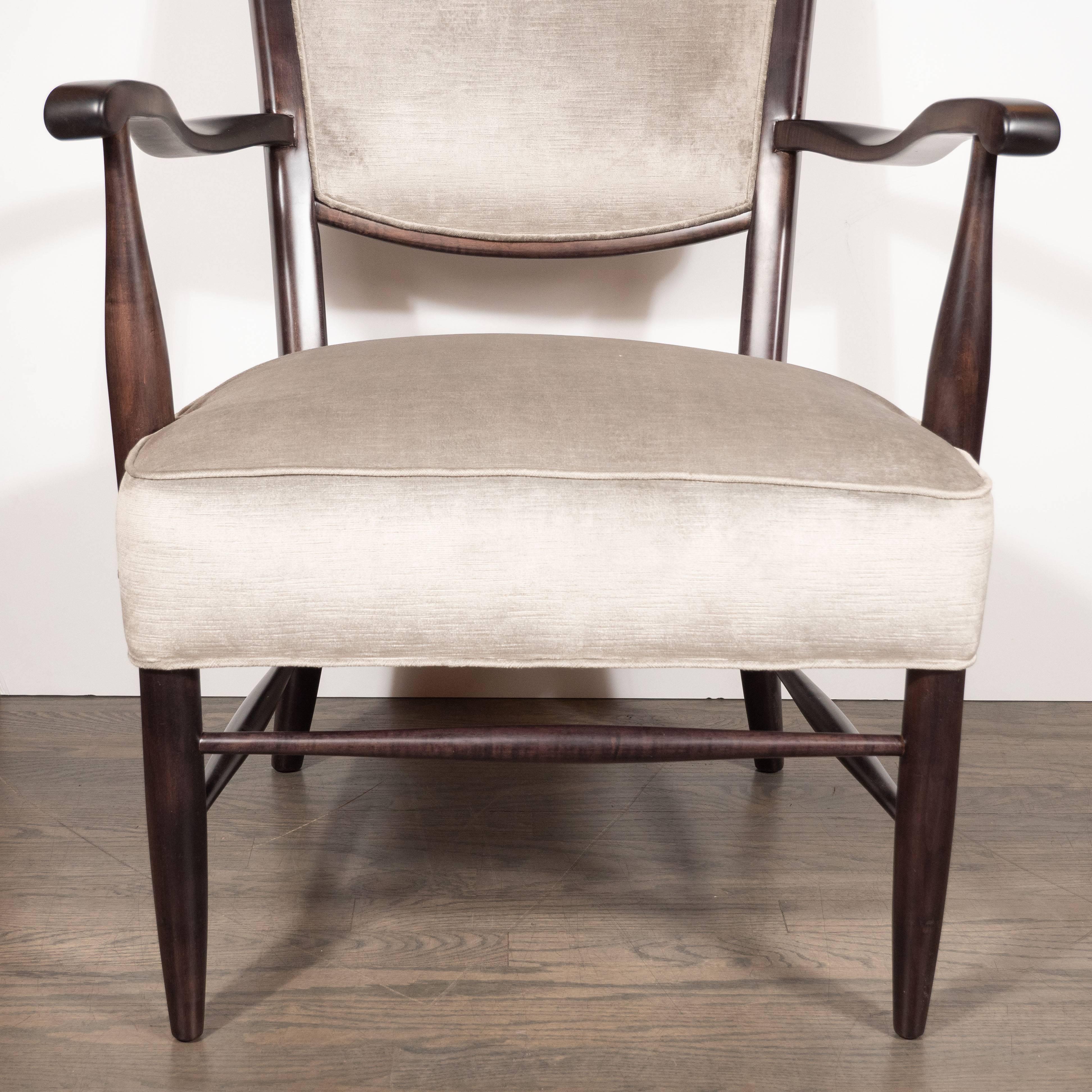 This elegant and sophisticated parsons chair was handmade in the United States by the esteemed maker Maxwell Royal, circa 1960. It features a gently undulating back with stiles that taper into ears that ascend above the top rail. Additionally, it