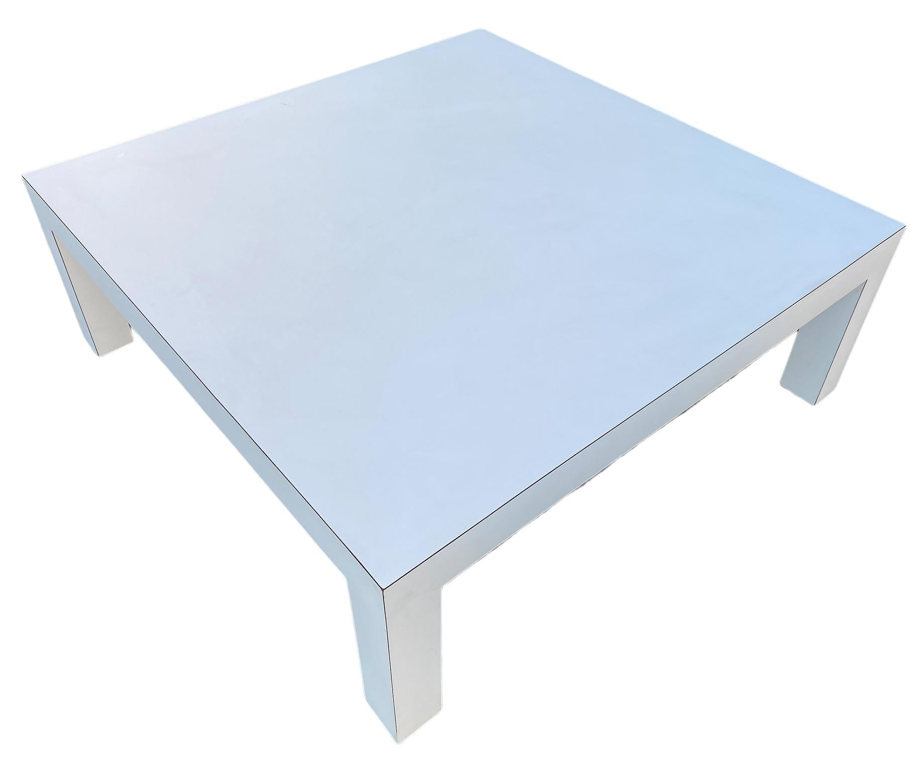 A Mid-Century Modern square white laminate Parsons coffee table. The table is in great original vintage condition High quality Laminate. Great design, clean table. Property Labeled DIA Design Institute of America, 1984

Measures: 42