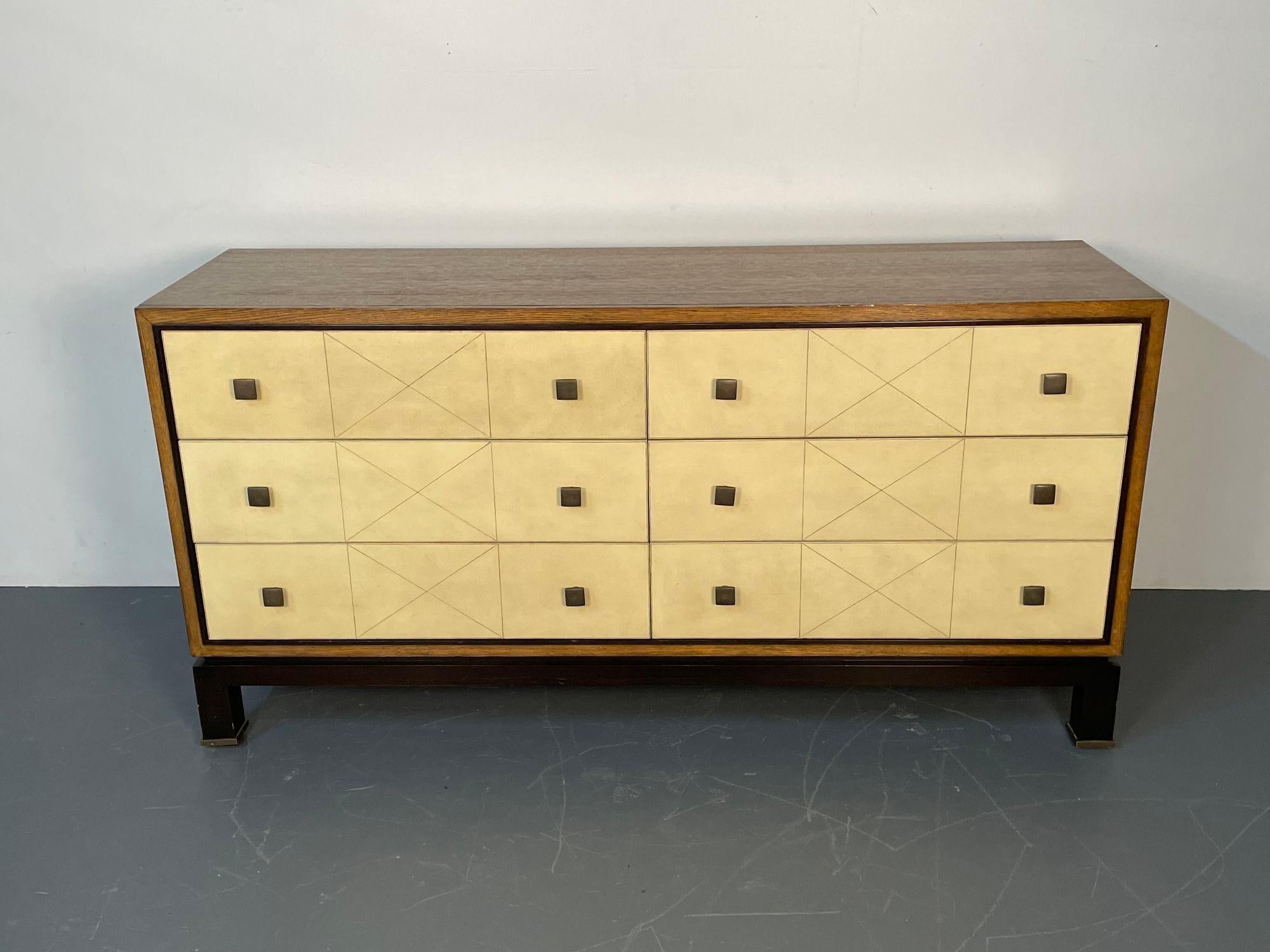 Mid-Century Modern Parzinger Style Parchment Dresser / Sideboard / Cabinet
 
Tommi Parzinger inspired mid-century chest of drawers. Six, three by three, parchment covered seemed drawers with metal handles sitting on a dark brown recessed base