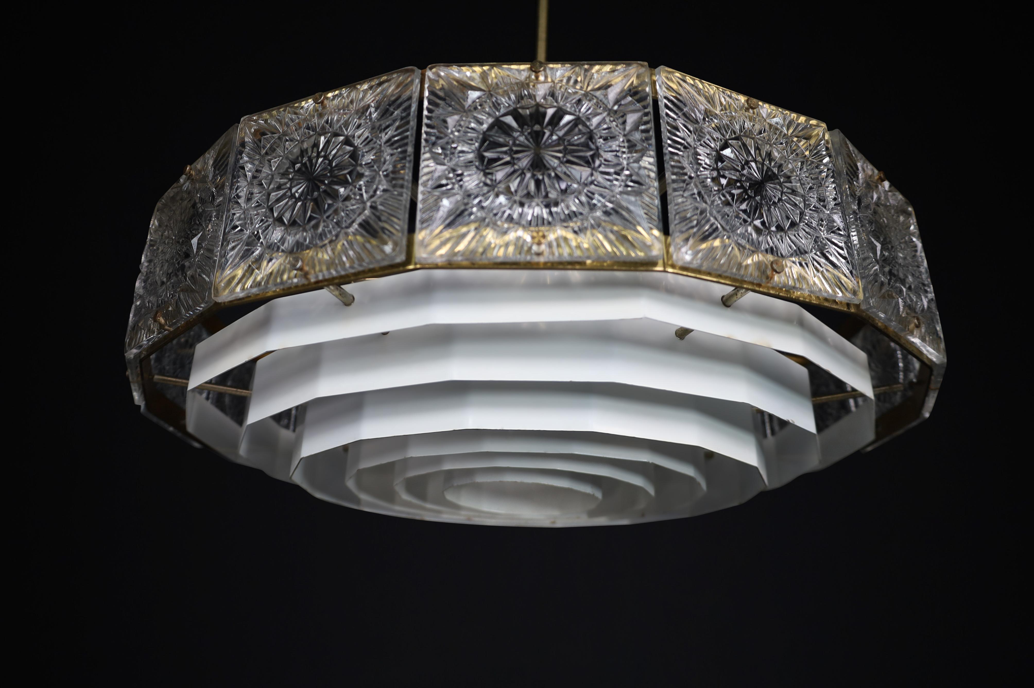 Mid-Century Modern Patinated Brass and Bohemian Glass Chandelier, 1970s — 3 Available, Price Per Item

Offered is a stunning Mid-Century Modern chandelier from the 1970s, crafted with exquisite Bohemian glass and patinated brass. Three identical