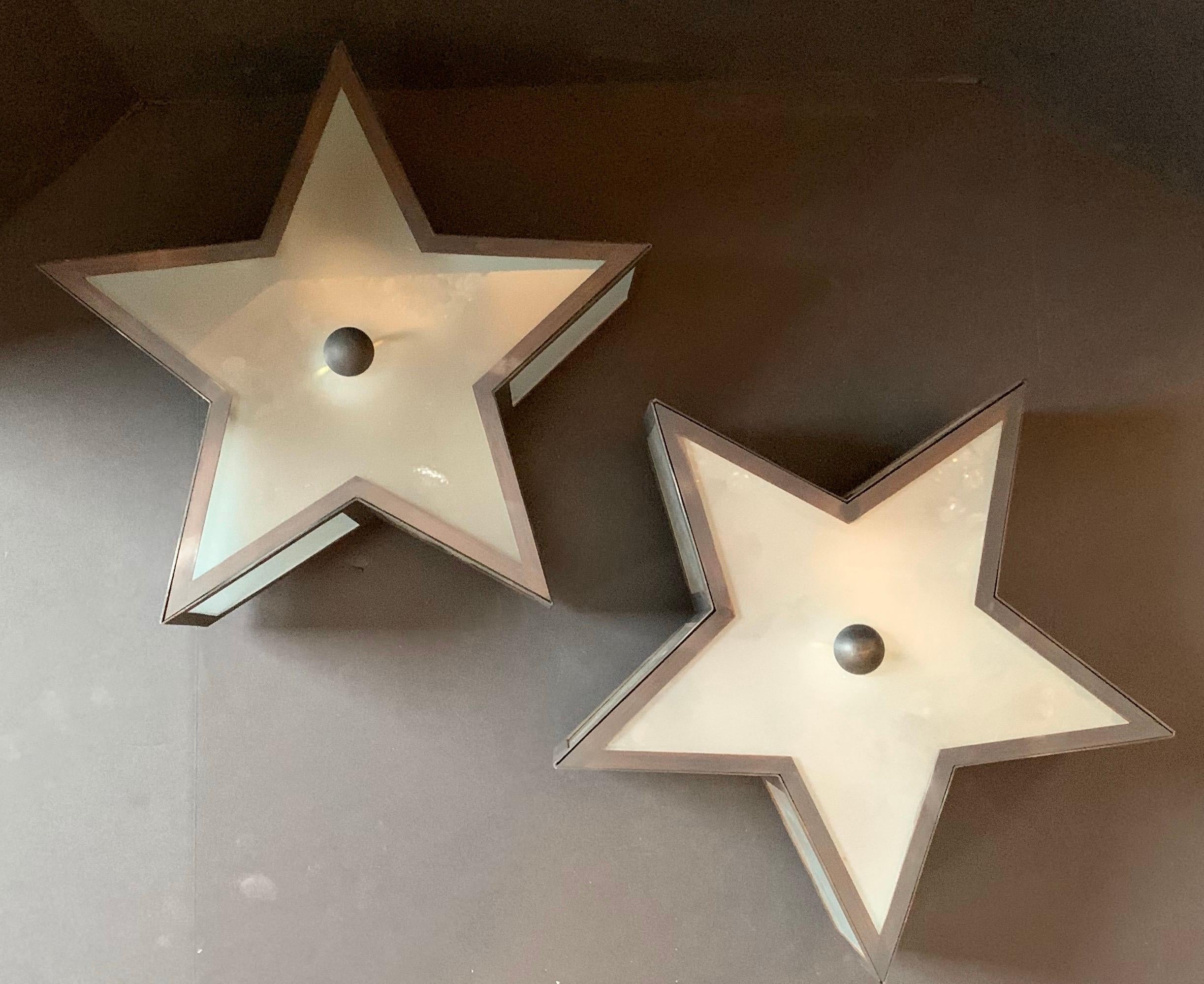 Wonderful Mid-Century Modern patinated bronze patina star form frosted glass flush mount light fixtures four available
Each sold separately.