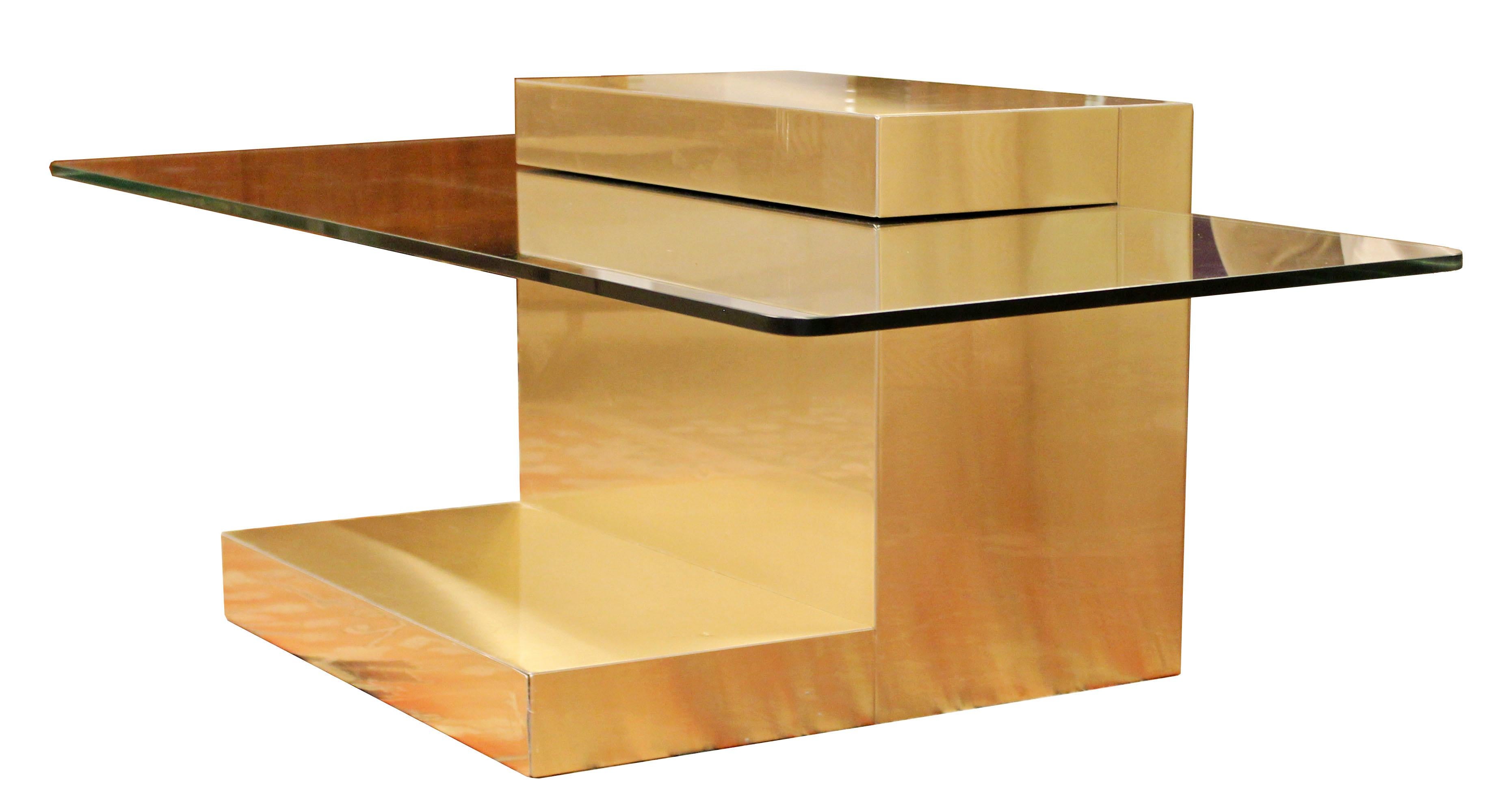 For your consideration is a phenomenal, cantilever, brass coffee table with a set in glass top, by Paul Evans, circa the 1960s. In good condition, with scratches and dents in the brass. The dimensions are 54