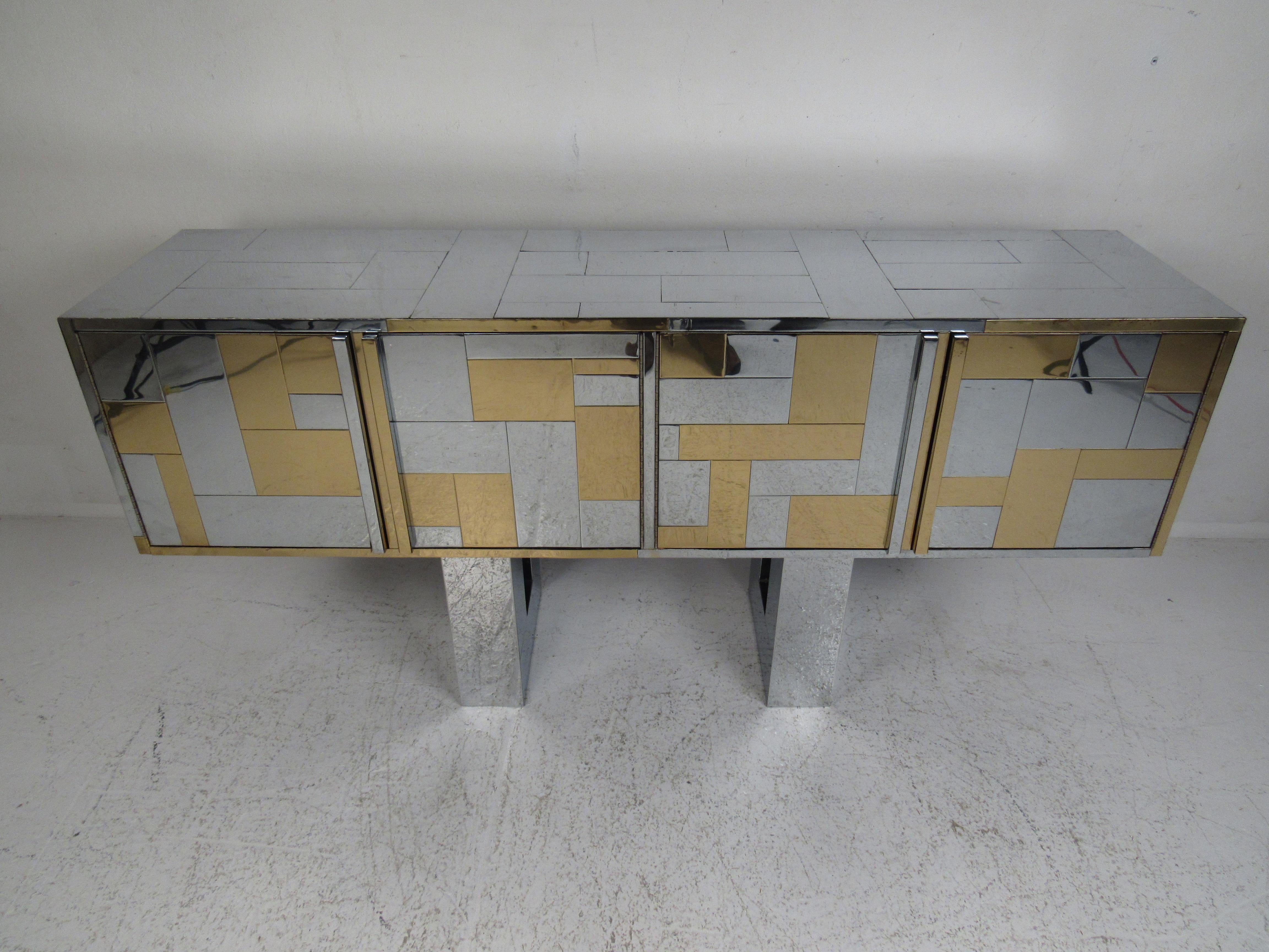 Elegant vintage sideboard by Paul Evans in metal with a two-tone cityscape design. The unique pedestal base has a cutout center adding to the allure. An exquisite case piece that offers plenty of room for storage within its large compartments with